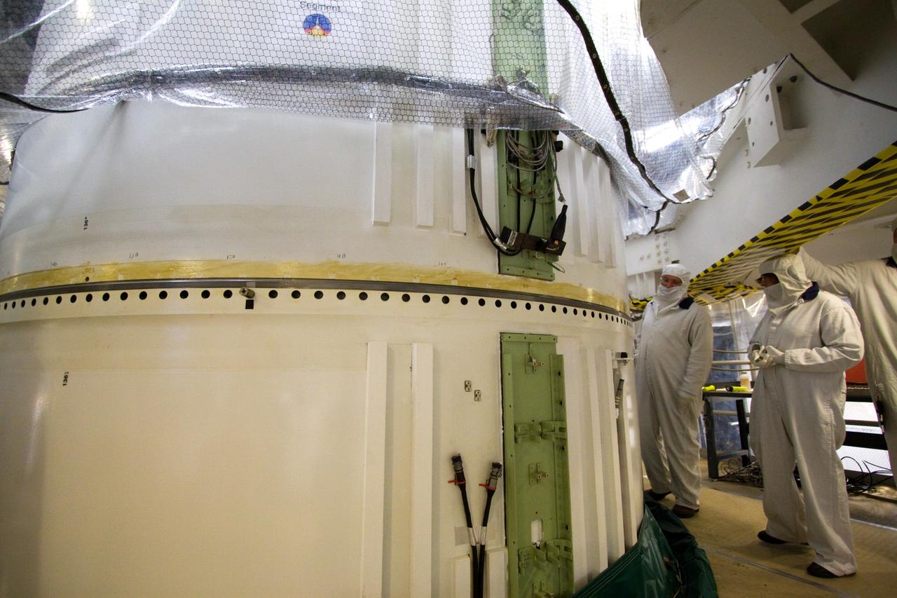 CAPE CANAVERAL, Fla. – In the Vehicle Assembly Building's High Bay 3 at NASA's Kennedy Space Center in Florida, the forward segment is mated to the forward center segment atop the aft assembly (aft segment and aft skirt). Part of the Constellation Program, the Ares I-X is the test vehicle for the Ares I, which is the essential core of a space transportation system that eventually will carry crewed missions back to the moon, on to Mars and out into the solar system . The Ares I-X flight test is targeted for no earlier than Aug. 30. Photo credit: NASA/Jack Pfaller