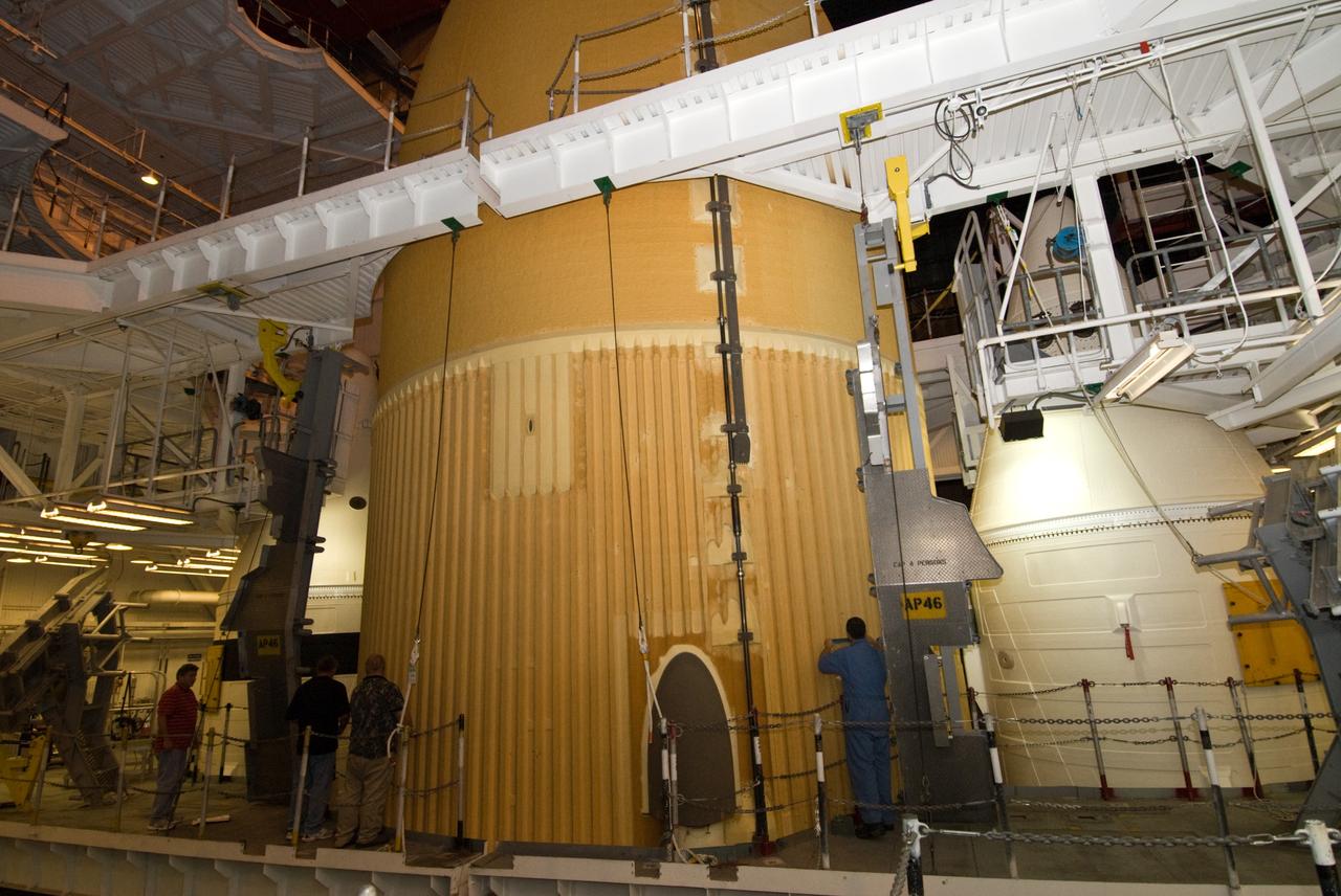 CAPE CANAVERAL, Fla. – In the Vehicle Assembly Building's High Bay 1 at NASA's Kennedy Space Center in Florida, workers begin "pull plug testing" on foam adhesion from the intertank of space shuttle Discovery's  external tank.  They are collecting 26 foam samples an inch-and-half in diameter for analysis to confirm the foam is bonded well to the metal primer underneath. The testing was prompted by the foam loss during launch of space shuttle Endeavour on the STS-127 mission July 15.  Samples are being sent to Michoud for study. Photo credit: NASA/Tim Jacobs