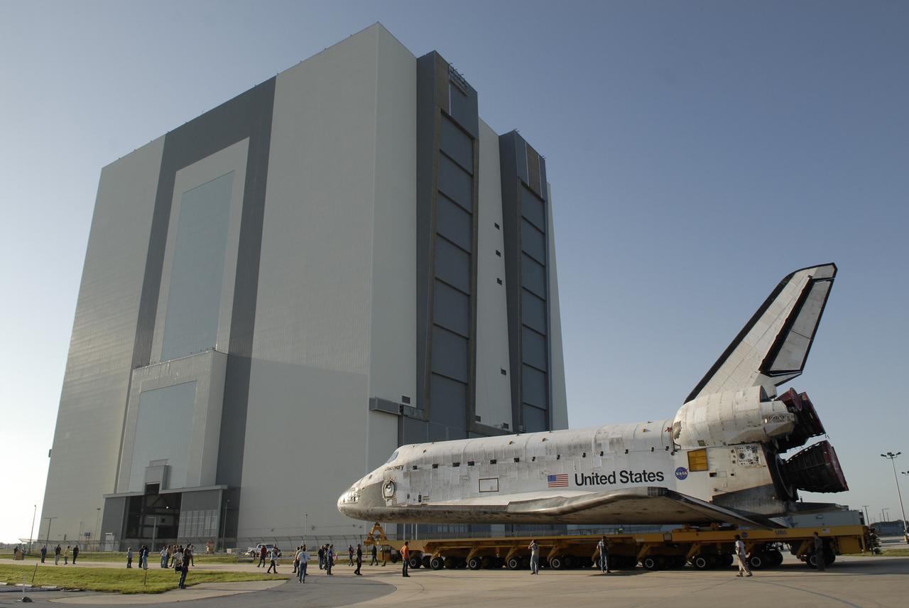 CAPE CANAVERAL, Fla. – Space shuttle Discovery rolls toward the Vehicle Assembly Building (in the background) at NASA's Kennedy Space Center, Fla. The first motion of the shuttle out of Orbiter Processing Facility 3 was at 7:22 a.m. EDT. In the VAB, Discovery will be lifted into High Bay 1 and mated to the external fuel tank and solid rocket boosters already installed on the mobile launcher platform. The shuttle is scheduled to roll out to Launch Pad 39A the first week of August to prepare for the STS-128 mission to the International Space Station. Discovery will carry the Leonardo Multi-Purpose Logistics Module containing life support racks and science racks and the Lightweight Multi-Purpose Experiment Support Structure Carrier in its payload bay. Launch of Discovery is targeted for late August. Photo credit: NASA/Kim Shiflett
