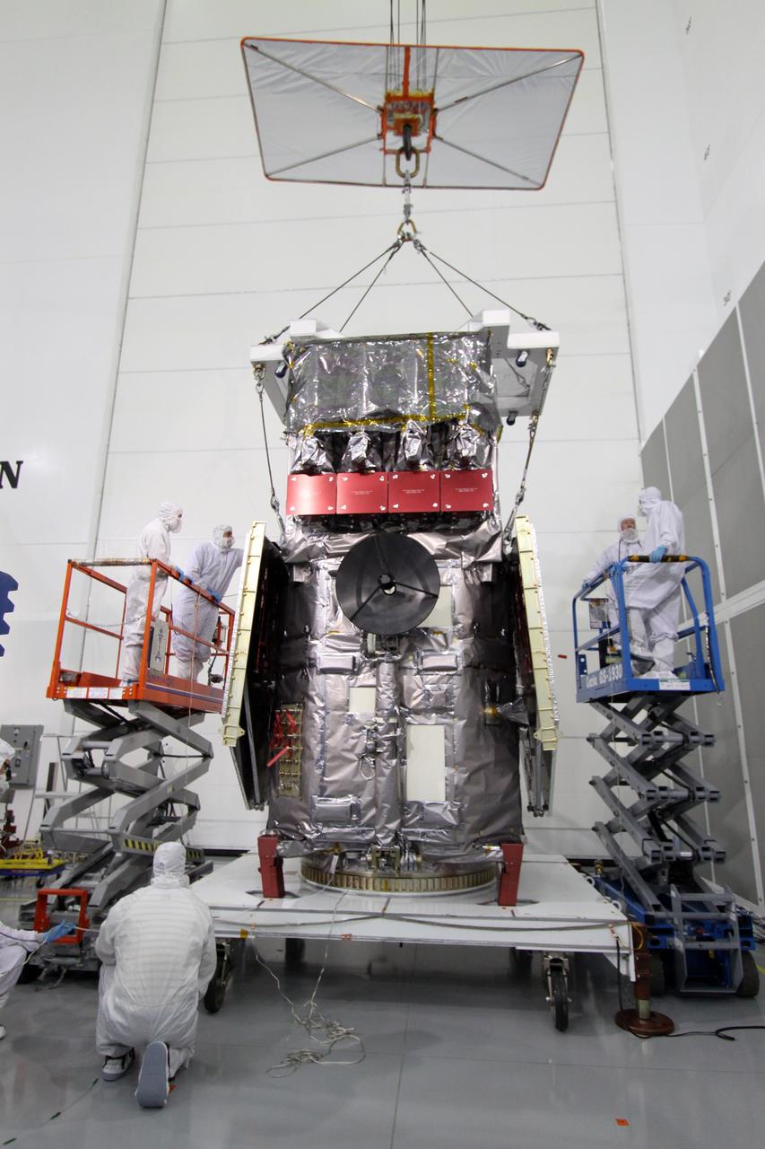 CAPE CANAVERAL, Fla. – At the Astrotech Payload Processing Facility in Titusville, Fla., technicians secure an overhead crane on the Solar Dynamics Observatory .  The crane will lift the spacecraft from the work stand and move it onto a Ransome table that will allow it to be rotated in various directions for access to different areas of the spacecraft. SDO is the first space weather research network mission in NASA's Living With a Star Program.  The spacecraft's long-term measurements will give solar scientists in-depth information about changes in the sun's magnetic field and insight into how they affect Earth.  In preparation for its anticipated November launch, engineers will perform a battery of comprehensive tests to ensure SDO can withstand the stresses and vibrations of the launch itself, as well as what it will encounter in the space environment after launch.  Photo credit: NASA/Jack Pfaller