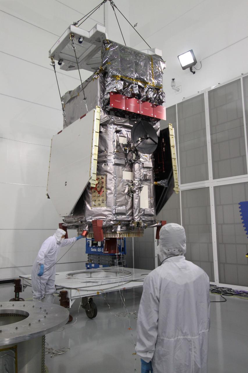 CAPE CANAVERAL, Fla. – At the Astrotech Payload Processing Facility in Titusville, Fla.,  the Solar Dynamics Observatory is lifted from the work stand under the guidance of technicians. The spacecraft is being moved onto a Ransome table that will allow it to be rotated in various directions for access to different areas of the spacecraft.  SDO is the first space weather research network mission in NASA's Living With a Star Program.  The spacecraft's long-term measurements will give solar scientists in-depth information about changes in the sun's magnetic field and insight into how they affect Earth.  In preparation for its anticipated November launch, engineers will perform a battery of comprehensive tests to ensure SDO can withstand the stresses and vibrations of the launch itself, as well as what it will encounter in the space environment after launch.  Photo credit: NASA/Jack Pfaller