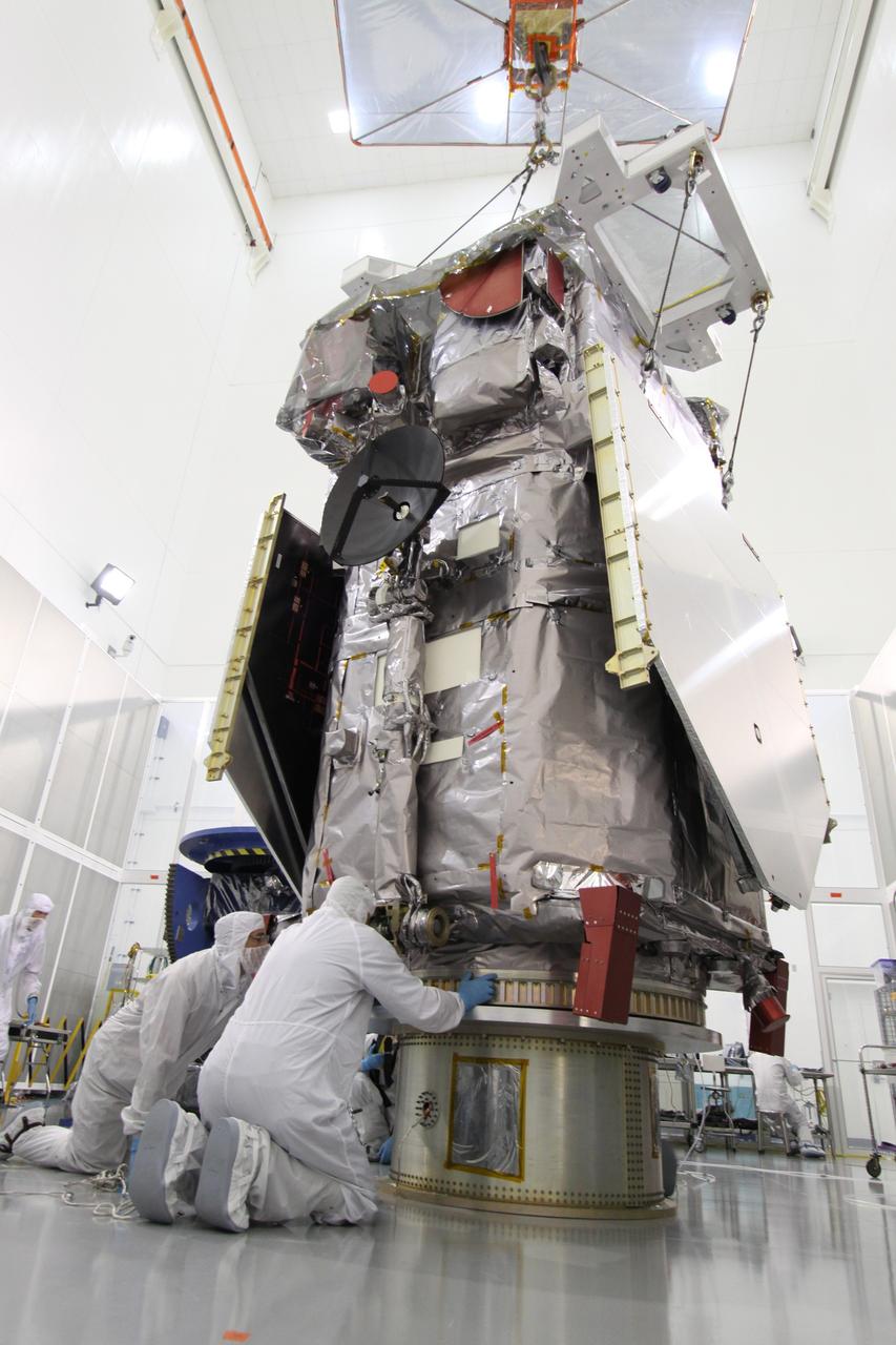 CAPE CANAVERAL, Fla. – At the Astrotech Payload Processing Facility in Titusville, Fla.,  technicians check the Solar Dynamics Observatory after it was lifted from its work stand.  The spacecraft is being moved onto a Ransome table that will allow it to be rotated in various directions for access to different areas of the spacecraft.  SDO is the first space weather research network mission in NASA's Living With a Star Program.  The spacecraft's long-term measurements will give solar scientists in-depth information about changes in the sun's magnetic field and insight into how they affect Earth.  In preparation for its anticipated November launch, engineers will perform a battery of comprehensive tests to ensure SDO can withstand the stresses and vibrations of the launch itself, as well as what it will encounter in the space environment after launch.  Photo credit: NASA/Jack Pfaller