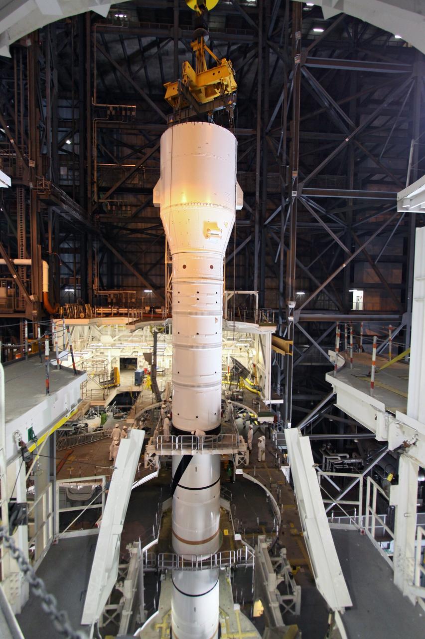 CAPE CANAVERAL, Fla. – In the Vehicle Assembly Building's High Bay 3, the Ares I-X "super stack 1" is being attached to the forward motor segment. Super stack 1 comprises the frustum, forward skirt, forward skirt extension, interstages 1 and 2 and the fifth segment simulator. Ares I-X is the test vehicle for the Ares I, which is part of the Constellation Program to return men to the moon and beyond. The Ares I-X flight test is targeted for Oct. 31, pending forma NASA Headquarters approval. Photo credit: NASA/Jack Pfaller