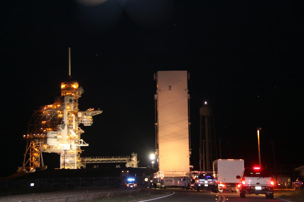 CAPE CANAVERAL, Fla. – The payload canister rolls toward Launch Pad 39A at NASA's Kennedy Space Center in Florida. Inside is the payload for space shuttle Discovery and the STS-128 mission, the Multi-Purpose Logistics Module Leonardo and the Lightweight Multi-Purpose Experiment Support Structure Carrier. Discovery's 13-day flight will deliver a new crew member and 33,000 pounds of equipment to the International Space Station. The equipment includes science and storage racks, a freezer to store research samples, a new sleeping compartment and the COLBERT treadmill. Launch of Discovery on its STS-128 mission is targeted for August 25. Photo credit: NASA/Jack Pfaller.
