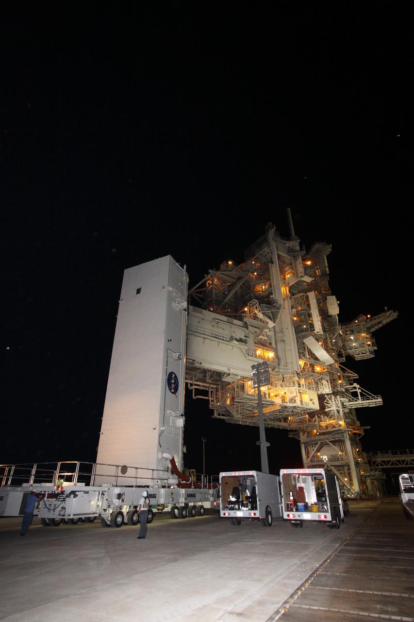 CAPE CANAVERAL, Fla. – The payload canister rolls onto Launch Pad 39A at NASA's Kennedy Space Center in Florida. Inside is the payload for space shuttle Discovery and the STS-128 mission, the Multi-Purpose Logistics Module Leonardo and the Lightweight Multi-Purpose Experiment Support Structure Carrier. Discovery's 13-day flight will deliver a new crew member and 33,000 pounds of equipment to the International Space Station. The equipment includes science and storage racks, a freezer to store research samples, a new sleeping compartment and the COLBERT treadmill. Launch of Discovery on its STS-128 mission is targeted for August 25. Photo credit: NASA/Jack Pfaller.