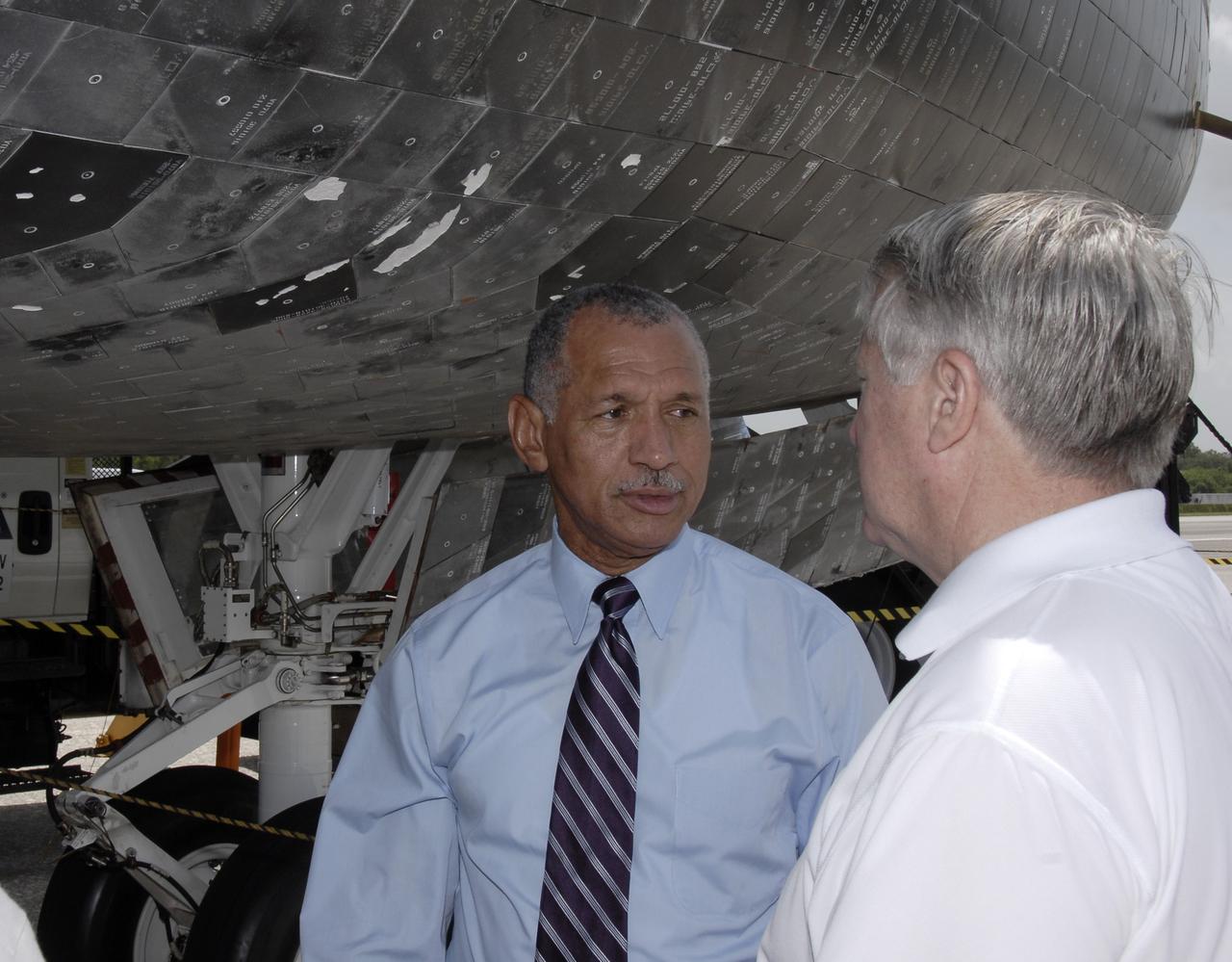 CAPE CANAVERAL, Fla. – NASA Administrator Charles Bolden (left) waits underneath space shuttle Endeavour for the STS-127 crew to emerge from the crew transport vehicle.  Endeavour's landing completed the 16-day, 6.5-million mile journey on the STS-127 mission to the International Space Station.  Endeavour's main gear touchdown was at 10:48:08 a.m. EDT. Nose gear touchdown was at 10:48:21 a.m. and wheels stop was at 10:49:13 a.m. Endeavour delivered the Japanese Experiment Module's Exposed Facility and the Experiment Logistics Module-Exposed Section to the International Space Station. The mission was the 29th flight to the station, the 23rd flight of Endeavour and the 127th in the Space Shuttle Program, as well as the 71st landing at Kennedy.   Photo credit: NASA/Kim Shiflett