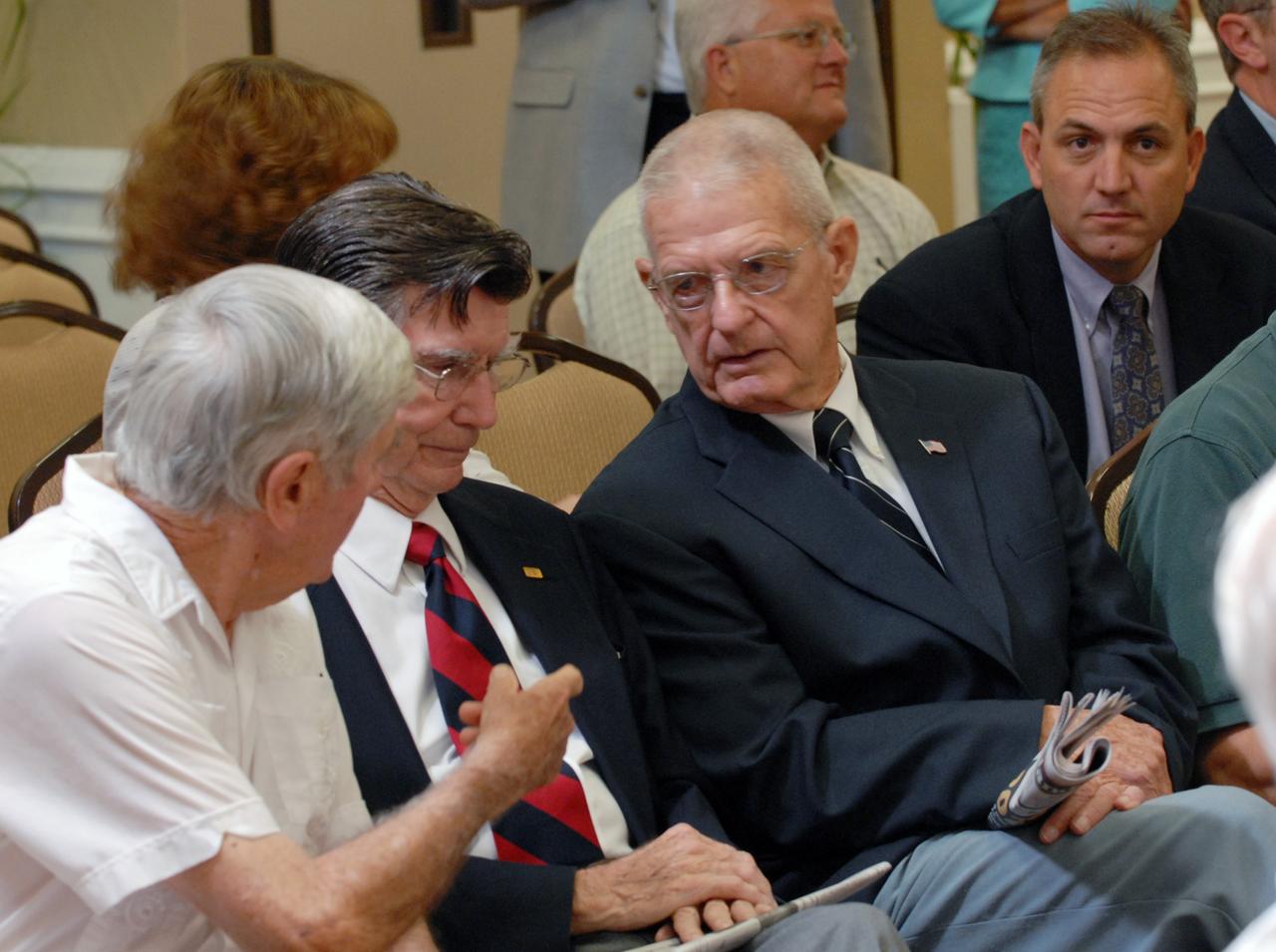 CAPE CANAVERAL, Fla. –  Spectators interested in the future of the Space Program discuss statements made during the public meeting of the Augustine Commission in Cocoa Beach, Fla. At the request of the Office of Science and Technology Policy, NASA established the Review of U.S. Human Space Flight Plans Committee, known as the Augustine Commission.  Chaired by Norman R. Augustine, retired chairman and CEO of Lockheed Martin Corp., the committee is conducting an independent review of ongoing U.S. human spaceflight plans and programs, as well as alternatives, to ensure the nation is pursuing the best trajectory for the future of human space flight - one that is safe, innovative, affordable, and sustainable.  Photo credit: NASA/Jim Grossmann