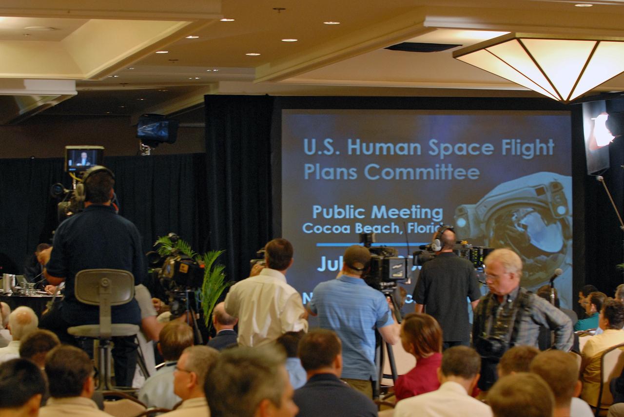 CAPE CANAVERAL, Fla. –  Photographers and spectators show their interest in the Augustine Commission, meeting in Cocoa Beach, Fla.  At the request of the Office of Science and Technology Policy, NASA established the Review of U.S. Human Space Flight Plans Committee, known as the Augustine Commission.  Chaired by  Norman R. Augustine, retired chairman and CEO of Lockheed Martin Corp.,  the committee is conducting an independent review of ongoing U.S. human spaceflight plans and programs, as well as alternatives, to ensure the nation is pursuing the best trajectory for the future of human space flight - one that is safe, innovative, affordable, and sustainable.  Photo credit: NASA/Jim Grossmann