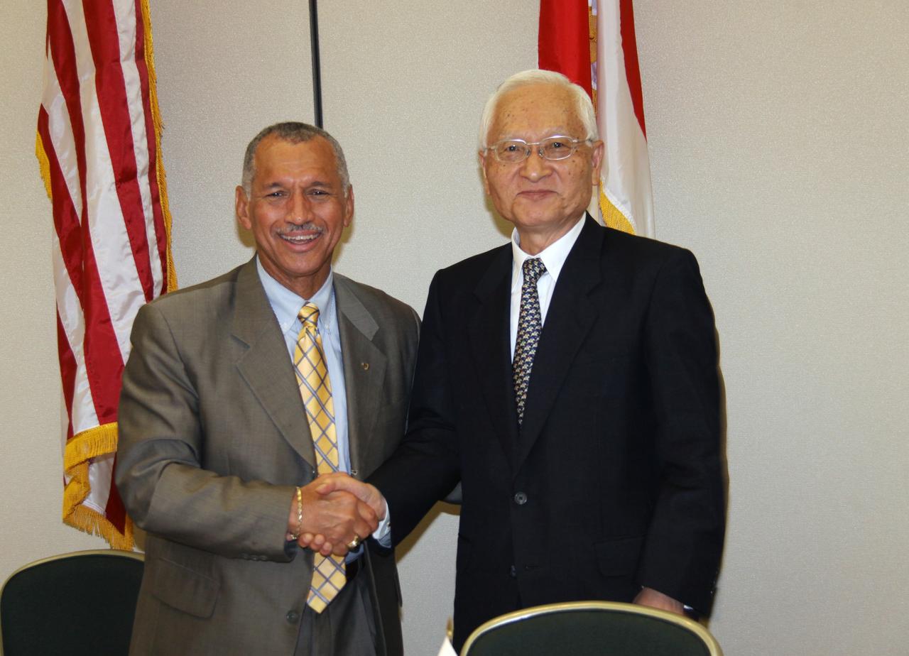 CAPE CANAVERAL, Fla. – NASA Administrator Charles Bolden (left) and Japan Aerospace Exploration Agency, or JAXA, President Keiji Tachikawa pose for photographers after signing an agreement defining the terms of cooperation between NASA and JAXA on the Global Precipitation Measurement, or GPM, mission. The ceremony took place July 30 at the Kennedy Space Center Visitor Complex, Fla. Through the agreement, NASA is responsible for the GPM core observatory spacecraft bus, the GPM Microwave Imager, or GMI, carried by it, and a second GMI to be flown on a partner-provided Low-Inclination Observatory. JAXA will supply the Dual-frequency Precipitation Radar for the core observatory, an H-IIA rocket for the core observatory's launch in July 2013, and data from a conical-scanning microwave imager on the upcoming Global Change Observation Mission satellite. Photo credit: NASA/Jack Pfaller