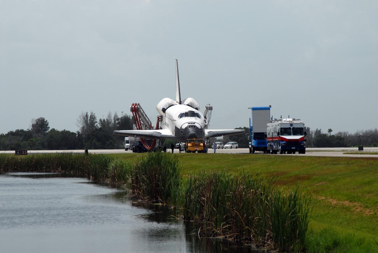 CAPE CANAVERAL, Fla. – At NASA's Kennedy Space Center in Florida, space shuttle Endeavour is towed away from the Shuttle Landing Facility.  It is being taken to the Orbiter Processing Facility #2.  Endeavour landed at 10:48 a.m. EDT, completing a journey of 6.5-million miles  on the STS-127 mission. Towing normally begins within four hours after landing and is completed within six hours unless removal of time-sensitive experiments is required on the runway. In the OPF, turnaround processing procedures on Endeavour will include various post-flight deservicing and maintenance functions, which are carried out in parallel with payload removal and the installation of equipment needed for the next mission. The STS-127 mission was the 29th flight to the station, the 23rd flight of Endeavour and the 71st landing at Kennedy.   Photo credit: NASA/Jim Grossmann