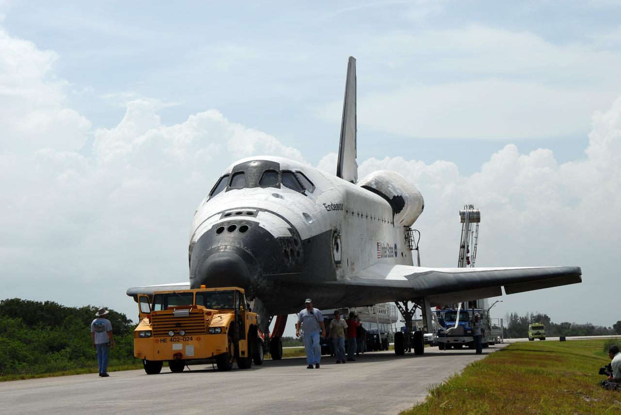 CAPE CANAVERAL, Fla. – At NASA's Kennedy Space Center in Florida, space shuttle Endeavour is towed away from the Shuttle Landing Facility.  It is being taken to the Orbiter Processing Facility #2.  Endeavour landed at 10:48 a.m. EDT, completing a journey of 6.5-million miles  on the STS-127 mission. Umbilicals are still attached to purge the vehicle of any possible residual explosive or toxic fumes. Towing normally begins within four hours after landing and is completed within six hours unless removal of time-sensitive experiments is required on the runway. In the OPF, turnaround processing procedures on Endeavour will include various post-flight deservicing and maintenance functions, which are carried out in parallel with payload removal and the installation of equipment needed for the next mission. The STS-127 mission was the 29th flight to the station, the 23rd flight of Endeavour and the 71st landing at Kennedy.   Photo credit: NASA/Jim Grossmann