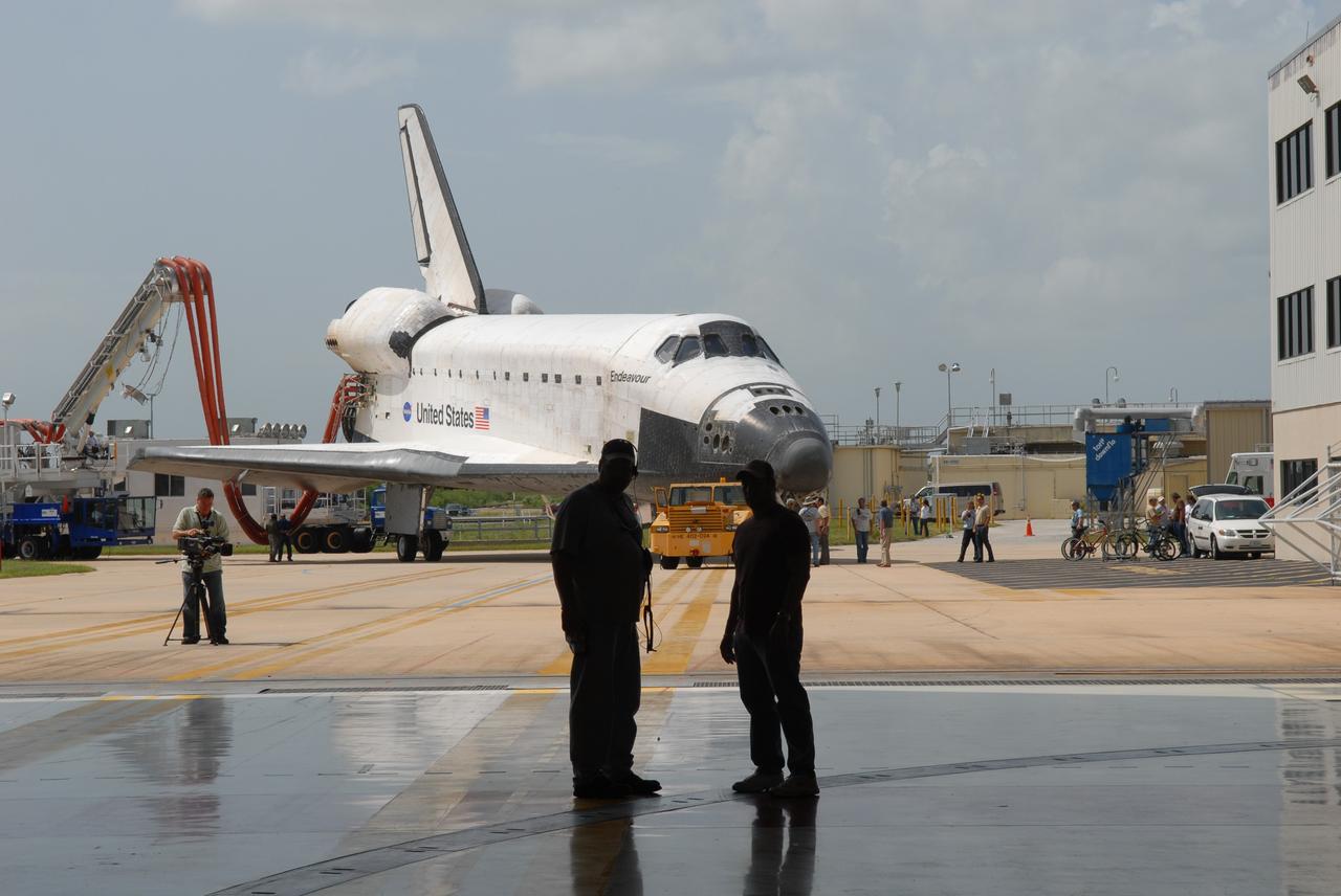 CAPE CANAVERAL, Fla. – At NASA's Kennedy Space Center in Florida, space shuttle Endeavour turns toward Orbiter Processing Facility #2.  Endeavour landed at 10:48 a.m. EDT, completing a journey of 6.5-million miles  on the STS-127 mission. Umbilicals are still attached to purge the vehicle of any possible residual explosive or toxic fumes. Towing normally begins within four hours after landing and is completed within six hours unless removal of time-sensitive experiments is required on the runway. In the OPF, turnaround processing procedures on Endeavour will include various post-flight deservicing and maintenance functions, which are carried out in parallel with payload removal and the installation of equipment needed for the next mission. The STS-127 mission was the 29th flight to the station, the 23rd flight of Endeavour and the 71st landing at Kennedy.   Photo credit: NASA/Jim Grossmann