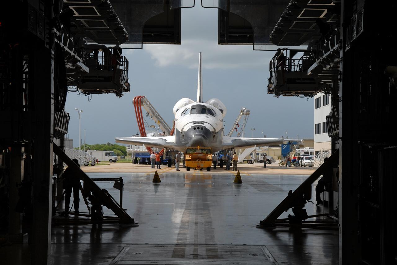 CAPE CANAVERAL, Fla. – At NASA's Kennedy Space Center in Florida, space shuttle Endeavour rolls into Orbiter Processing Facility #2.  Endeavour landed at 10:48 a.m. EDT, completing a journey of 6.5-million miles  on the STS-127 mission. Umbilicals are still attached to purge the vehicle of any possible residual explosive or toxic fumes. Towing normally begins within four hours after landing and is completed within six hours unless removal of time-sensitive experiments is required on the runway. In the OPF, turnaround processing procedures on Endeavour will include various post-flight deservicing and maintenance functions, which are carried out in parallel with payload removal and the installation of equipment needed for the next mission. The STS-127 mission was the 29th flight to the station, the 23rd flight of Endeavour and the 71st landing at Kennedy.   Photo credit: NASA/Jim Grossmann