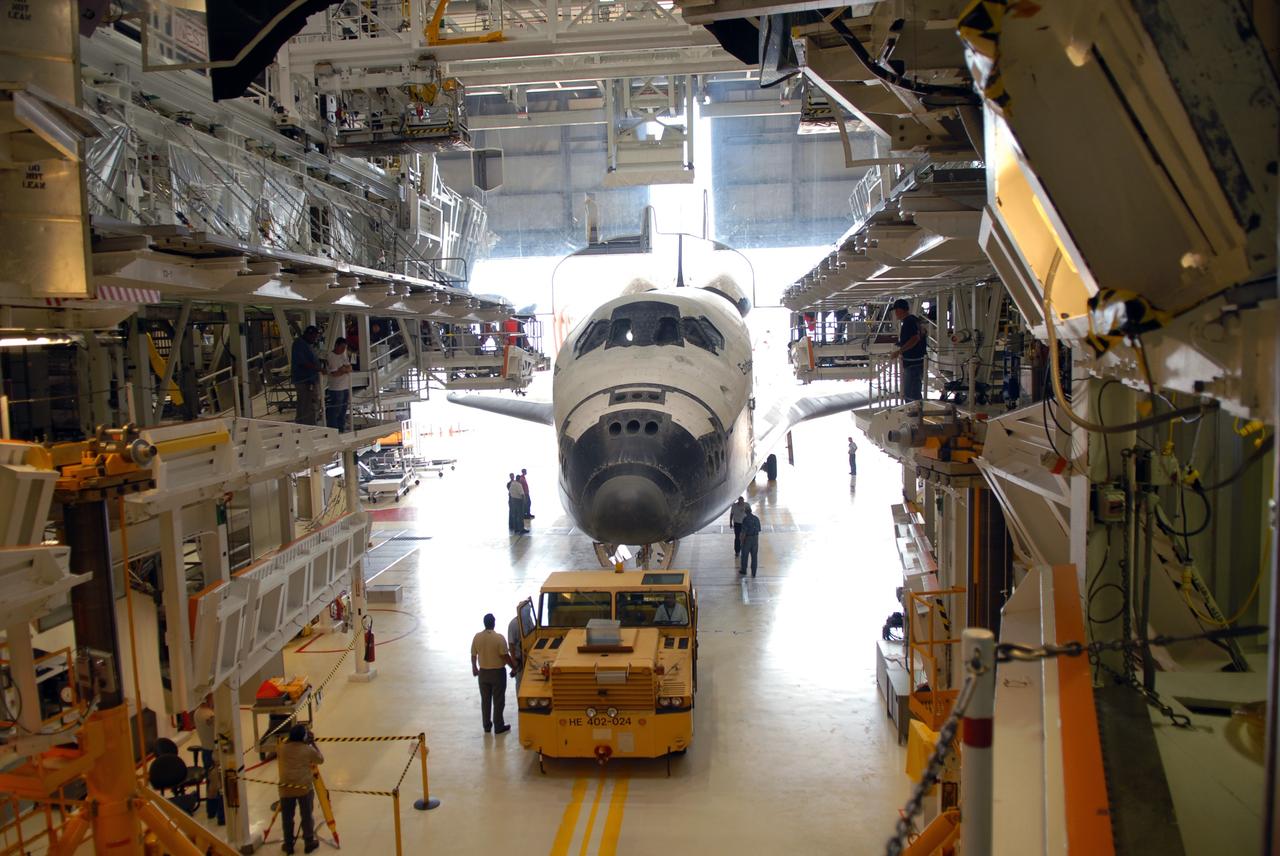CAPE CANAVERAL, Fla. – At NASA's Kennedy Space Center in Florida, space shuttle Endeavour rolls into Orbiter Processing Facility #2.  Endeavour landed at 10:48 a.m. EDT, completing a journey of 6.5-million miles  on the STS-127 mission. Umbilicals are still attached to purge the vehicle of any possible residual explosive or toxic fumes. Towing normally begins within four hours after landing and is completed within six hours unless removal of time-sensitive experiments is required on the runway. In the OPF, turnaround processing procedures on Endeavour will include various post-flight deservicing and maintenance functions, which are carried out in parallel with payload removal and the installation of equipment needed for the next mission. The STS-127 mission was the 29th flight to the station, the 23rd flight of Endeavour and the 71st landing at Kennedy.   Photo credit: NASA/Jim Grossmann