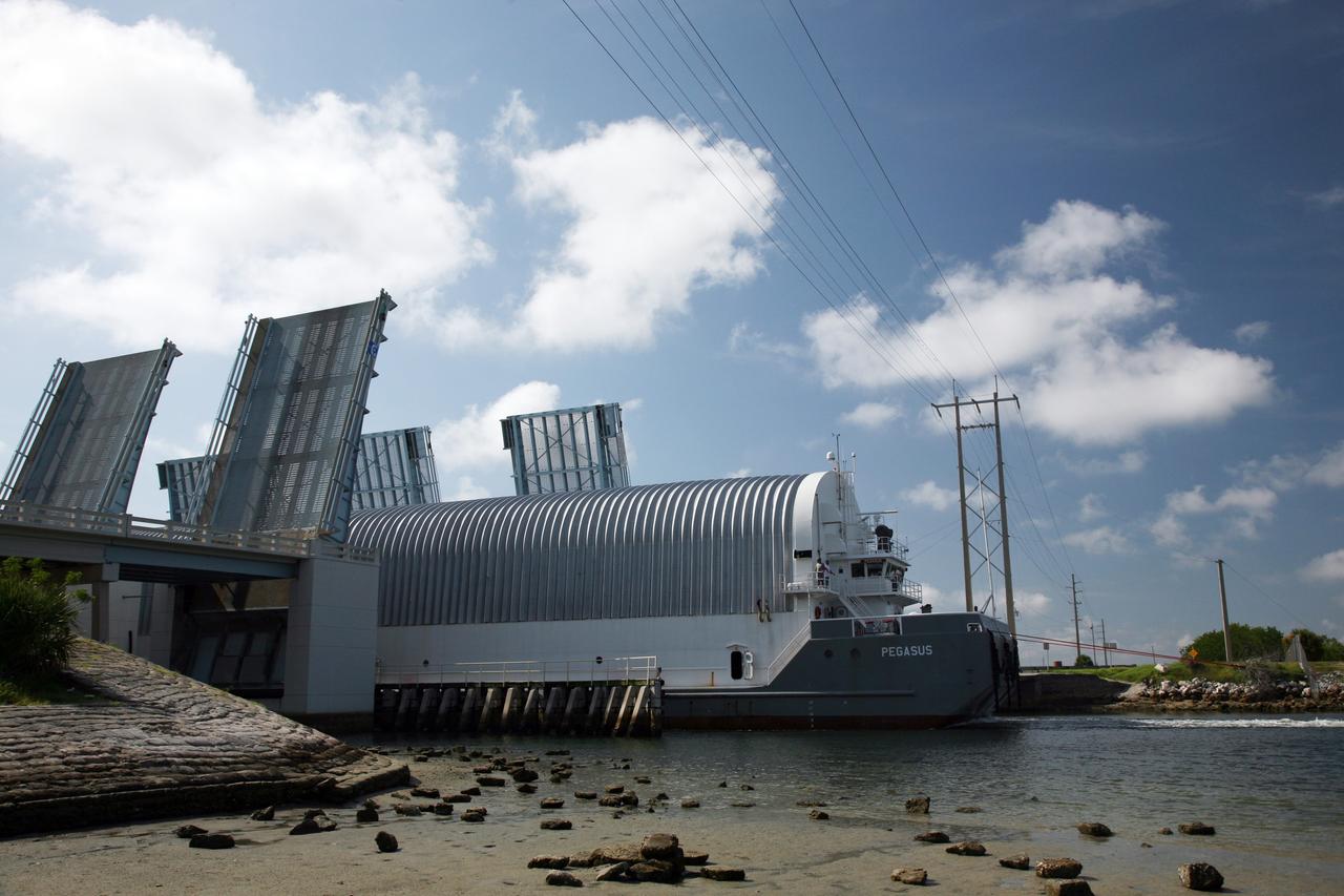 CAPE CANAVERAL, Fla. – NASA's Pegasus barge moves through the bridge at Port Canaveral, Fla.  The barge contains the external fuel tank designated ET-133 that will be used for space shuttle Atlantis' STS-129 mission.  The barge is delivering the external tank to the Turn Basin dock at NASA's Kennedy Space Center in Florida where it will be offloaded and moved into the Vehicle Assembly Building.  The tank was shipped aboard the Pegasus from NASA's Michould Assembly Facility near New Orleans. Pegasus was towed to Port Canaveral by the Freedom Star Retrieval Ship.  Photo credit: NASA/Troy Cryder