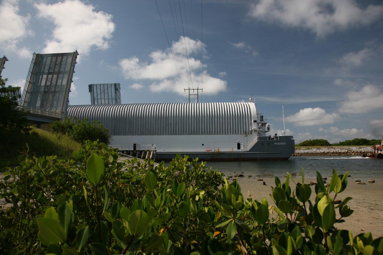 CAPE CANAVERAL, Fla. – NASA's Pegasus barge moves through the bridge at Port Canaveral, Fla.  The barge contains the external fuel tank designated ET-133 that will be used for space shuttle Atlantis' STS-129 mission.  The barge is delivering the external tank to the Turn Basin dock at NASA's Kennedy Space Center in Florida where it will be offloaded and moved into the Vehicle Assembly Building.  The tank was shipped aboard the Pegasus from NASA's Michould Assembly Facility near New Orleans. Pegasus was towed to Port Canaveral by the Freedom Star Retrieval Ship.  Photo credit: NASA/Troy Cryder