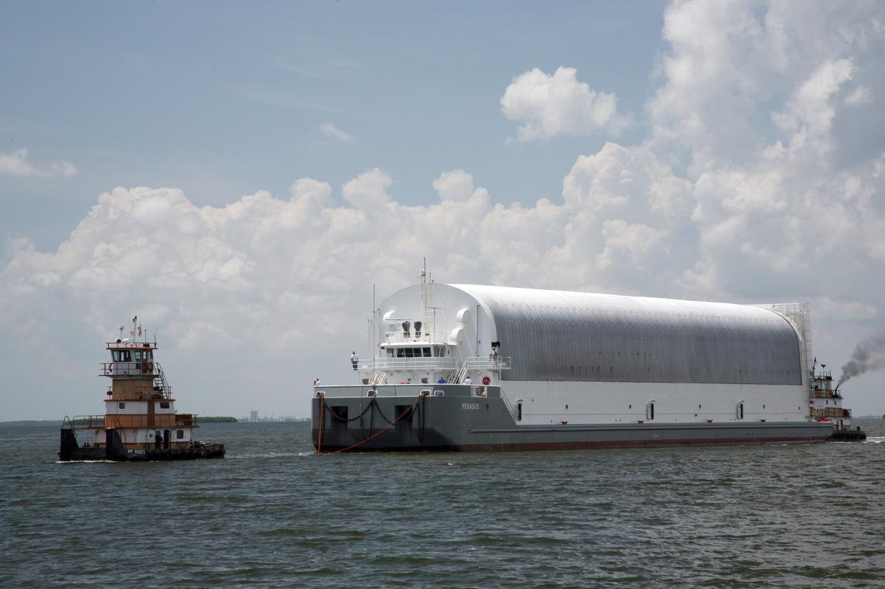 CAPE CANAVERAL, Fla. – NASA's Pegasus barge is towed on the Banana River to the Launch Complex 39 area at NASA's Kennedy Space Center in Florida. The barge contains the external fuel tank, designated ET-133, that will be used for space shuttle Atlantis' STS-129 mission.  After arrival at the Turn Basin dock, the tank will be offloaded and moved into a high bay in the Vehicle Assembly Building for checkout. The tank was shipped aboard the Pegasus from NASA's Michould Assembly Facility near New Orleans. Pegasus was towed to Port Canaveral by the Freedom Star Retrieval Ship.  Photo credit: NASA/Dimitri Gerondidakis