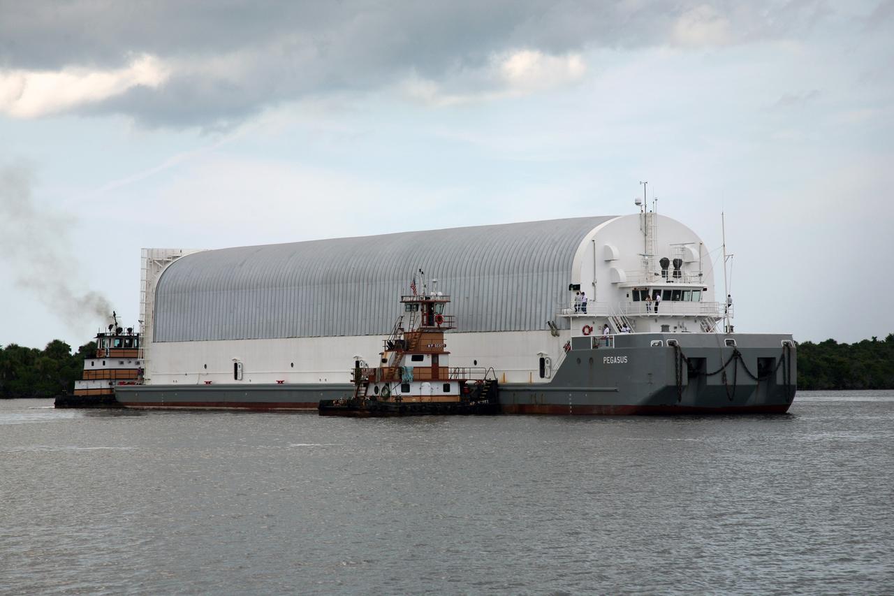 CAPE CANAVERAL, Fla. – Tugboats maneuver NASA's Pegasus barge toward the Turn Basin dock at NASA's Kennedy Space Center in Florida. The barge contains the external fuel tank, designated ET-133, that will be used for space shuttle Atlantis' STS-129 mission.  After Pegasus is docked, the tank will be offloaded and moved into a high bay in the Vehicle Assembly Building for checkout.  The tank was shipped aboard the Pegasus from NASA's Michould Assembly Facility near New Orleans. Pegasus was towed to Port Canaveral by the Freedom Star Retrieval Ship.  Photo credit: NASA/Dimitri Gerondidakis