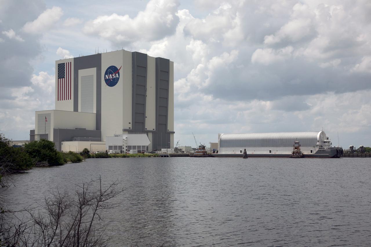 CAPE CANAVERAL, Fla. – Tugboats maneuver NASA's Pegasus barge next to the Turn Basin dock at NASA's Kennedy Space Center in Florida. The barge contains the external fuel tank, designated ET-133, that will be used for space shuttle Atlantis' STS-129 mission.  The tank will be offloaded and moved into a high bay in the Vehicle Assembly Building, at left, for checkout.  The tank was shipped aboard the Pegasus from NASA's Michould Assembly Facility near New Orleans. Pegasus was towed to Port Canaveral by the Freedom Star Retrieval Ship.  Photo credit: NASA/Dimitri Gerondidakis