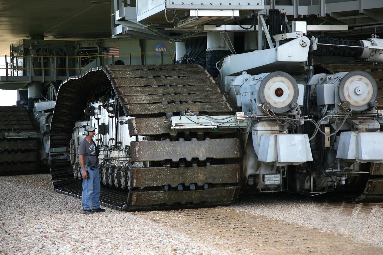 CAPE CANAVERAL, Fla. –At NASA's Kennedy Space Center in Florida, a worker checks the tread on the crawler-transporter as it carries space shuttle Endeavour to Launch Pad 39A. The 3.4-mile journey was slower than usual as technicians stopped several times to clear mud from the crawler's treads and bearings caused by the waterlogged crawlerway. First motion out of the Vehicle Assembly Building was at 2:07 a.m. EDT Aug. 4. Rollout was delayed approximately 2 hours due to lightning in the area. Discovery's 13-day flight will deliver a new crew member and 33,000 pounds of equipment to the International Space Station. The equipment includes science and storage racks, a freezer to store research samples, a new sleeping compartment and the COLBERT treadmill. Launch of Discovery on its STS-128 mission is targeted for late August. Photo credit: NASA/Dimitri Gerondidakis