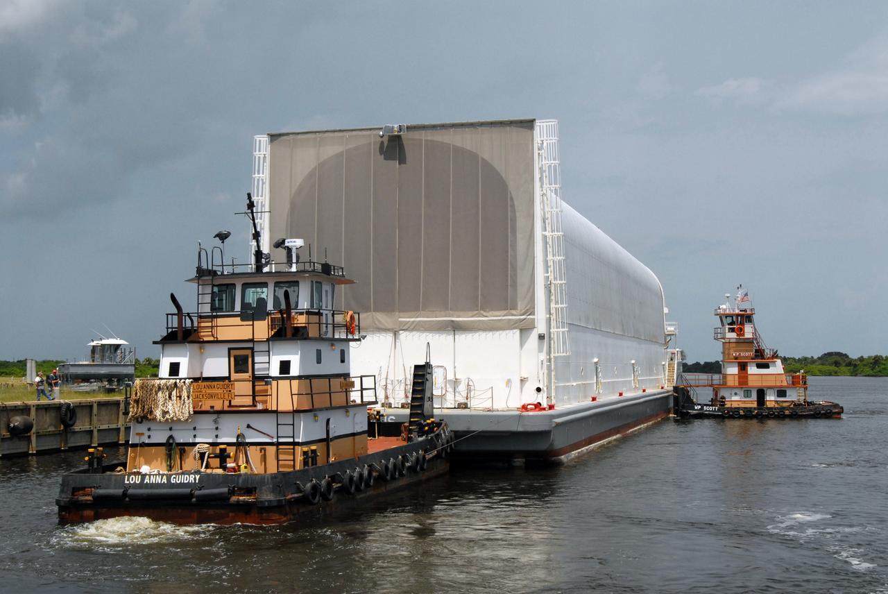 CAPE CANAVERAL, Fla. – Tugboats maneuver NASA's Pegasus barge next to the Turn Basin dock at NASA's Kennedy Space Center in Florida. The barge contains the external fuel tank, designated ET-133, that will be used for space shuttle Atlantis' STS-129 mission.  The tank will be offloaded and moved into a high bay in the Vehicle Assembly Building for checkout.  The tank was shipped aboard the Pegasus from NASA's Michoud Assembly Facility near New Orleans. Pegasus was towed to Port Canaveral by the Freedom Star Retrieval Ship. Launch of Atlantis is targeted for November.  Photo credit: NASA/Tim Jacobs