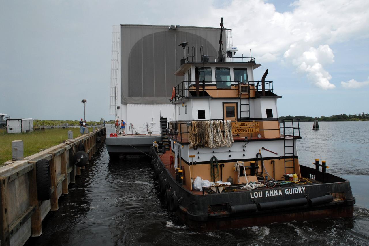 CAPE CANAVERAL, Fla. – Tugboats maneuver NASA's Pegasus barge next to the Turn Basin dock at NASA's Kennedy Space Center in Florida. The barge contains the external fuel tank, designated ET-133, that will be used for space shuttle Atlantis' STS-129 mission.  The tank will be offloaded and moved into a high bay in the Vehicle Assembly Building for checkout. The tank will be offloaded and moved into a high bay in the Vehicle Assembly Building for checkout.  The tank was shipped aboard the Pegasus from NASA's Michoud Assembly Facility near New Orleans. Pegasus was towed to Port Canaveral by the Freedom Star Retrieval Ship. Launch of Atlantis is targeted for November.  Photo credit: NASA/Tim Jacobs