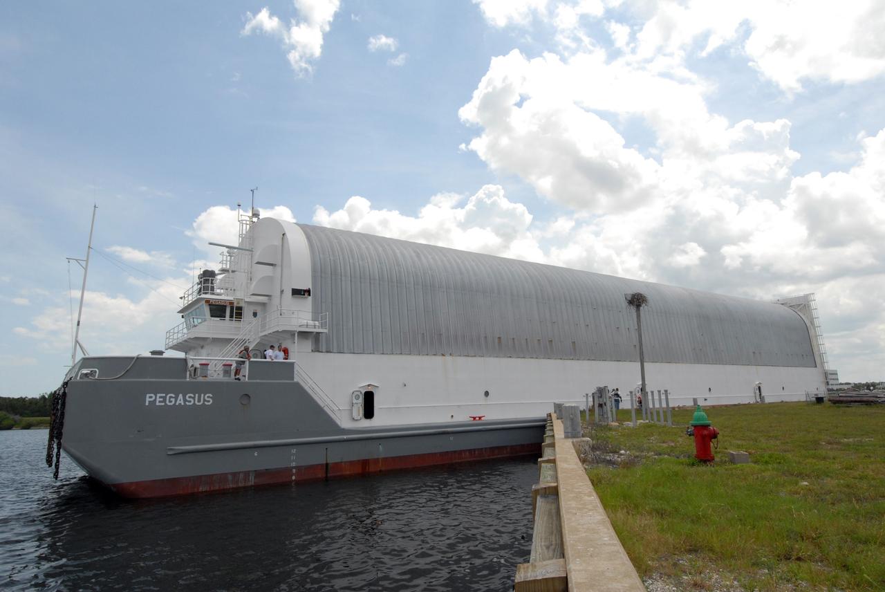 CAPE CANAVERAL, Fla. – NASA's Pegasus barge is pushed next to the Turn Basin dock at NASA's Kennedy Space Center in Florida. The barge contains the external fuel tank, designated ET-133, that will be used for space shuttle Atlantis' STS-129 mission.  The tank will be offloaded and moved into a high bay in the Vehicle Assembly Building for checkout.  The tank was shipped aboard the Pegasus from NASA's Michoud Assembly Facility near New Orleans. Pegasus was towed to Port Canaveral by the Freedom Star Retrieval Ship. Launch of Atlantis is targeted for November.  Photo credit: NASA/Tim Jacobs