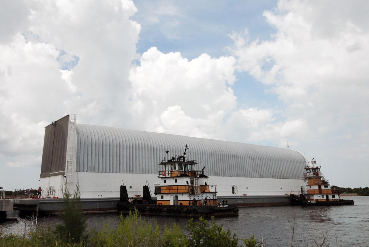 CAPE CANAVERAL, Fla. – Tugboats maneuver NASA's Pegasus barge into to the Turn Basin dock at NASA's Kennedy Space Center in Florida. The barge contains the external fuel tank, designated ET-133, that will be used for space shuttle Atlantis' STS-129 mission.  The tank will be offloaded and moved into a high bay in the Vehicle Assembly Building for checkout. The tank was shipped aboard the Pegasus from NASA's Michoud Assembly Facility near New Orleans. Pegasus was towed to Port Canaveral by the Freedom Star Retrieval Ship. Launch of Atlantis is targeted for November.  Photo credit: NASA/Tim Jacobs