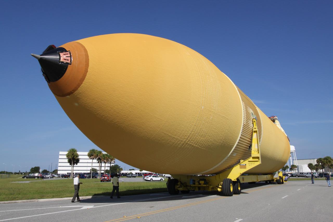 CAPE CANAVERAL, Fla. – At NASA's Kennedy Space Center in Florida, the external fuel tank designated ET-133 is transported from the Turn Basin to the Vehicle Assembly Building, behind it. The tank will be used for space shuttle Atlantis' STS-129 mission. In the VAB, the tank will be moved into a high bay for checkout. The tank was shipped aboard the Pegasus from NASA's Michoud Assembly Facility near New Orleans. Pegasus was towed to Port Canaveral by the Freedom Star Retrieval Ship. Launch of Atlantis is targeted for November. Photo credit: NASA/Troy Cryder
