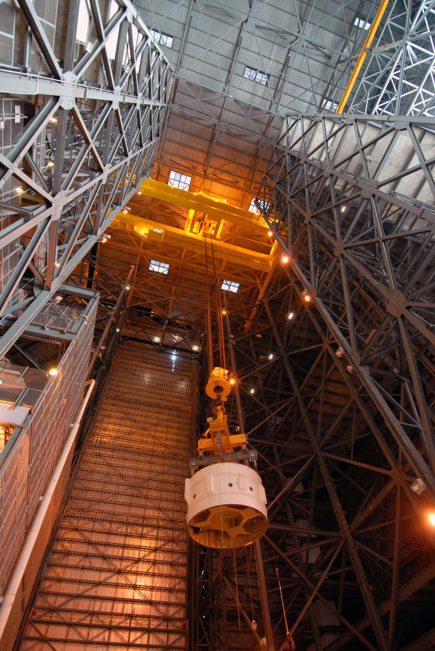 CAPE CANAVERAL, Fla. – In the Vehicle Assembly Building's High Bay 4 at NASA's Kennedy Space Center in Florida, a crane lifts Super Stack 2, part of the Ares I-X upper stage, into the upper levels. The stack is being moved across the transfer aisle for attachment to Super Stack 1 in High Bay 3. The upper stage comprises five super stacks, which are integrated with the four-segment solid rocket booster first stage on the mobile launch platform. Ares I-X is the test vehicle for the Ares I, which is part of the Constellation Program to return men to the moon and beyond. The Ares I-X flight test is targeted for Oct. 31, pending formal NASA Headquarters approval. Photo credit: NASA/Tim Jacobs