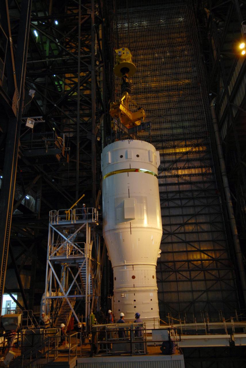 CAPE CANAVERAL, Fla. – In the Vehicle Assembly Building's High Bay 3 at NASA's Kennedy Space Center in Florida, a crane lowers Super Stack 2, part of the Ares I-X upper stage, for attachment with Super Stack 1 below. The upper stage comprises five super stacks, which are integrated with the four-segment solid rocket booster first stage on the mobile launch platform. Ares I-X is the test vehicle for the Ares I, which is part of the Constellation Program to return men to the moon and beyond. The Ares I-X flight test is targeted for Oct. 31, pending formal NASA Headquarters approval. Photo credit: NASA/Tim Jacobs