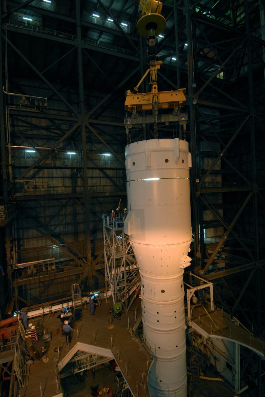 CAPE CANAVERAL, Fla. – In the Vehicle Assembly Building's High Bay 3 at NASA's Kennedy Space Center in Florida, a crane lowers Super Stack 2, part of the Ares I-X upper stage, onto Super Stack 1 for integration. The upper stage comprises five super stacks, which are integrated with the four-segment solid rocket booster first stage on the mobile launch platform. Ares I-X is the test vehicle for the Ares I, which is part of the Constellation Program to return men to the moon and beyond. The Ares I-X flight test is targeted for Oct. 31, pending formal NASA Headquarters approval. Photo credit: NASA/Tim Jacobs