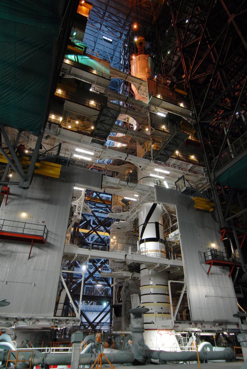 CAPE CANAVERAL, Fla. – In the Vehicle Assembly Building's High Bay 3 at NASA's Kennedy Space Center in Florida, a crane has lowered Super Stack 2, part of the Ares I-X upper stage, onto Super Stack 1 for assembly. The upper stage comprises five super stacks, which are integrated with the four-segment solid rocket booster first stage on the mobile launch platform. Ares I-X is the test vehicle for the Ares I, which is part of the Constellation Program to return men to the moon and beyond. The Ares I-X flight test is targeted for Oct. 31, pending formal NASA Headquarters approval. Photo credit: NASA/Tim Jacobs