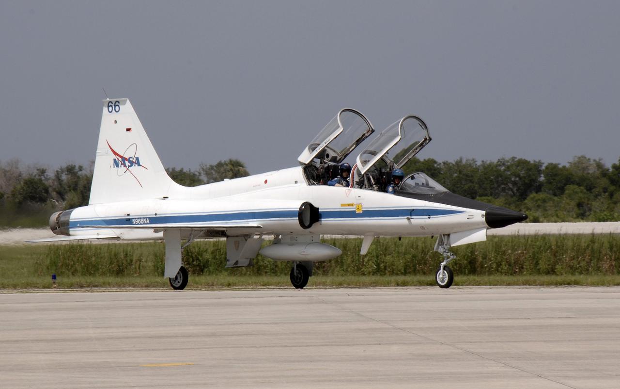 CAPE CANAVERAL, Fla. – Space shuttle Discovery's STS-128 Commander Rick Sturckow taxis the T-38 training jet onto NASA Kennedy Space Center's Shuttle Landing Facility. Mission Specialist Patrick Forrester is in the seat behind him. The astronauts will be taking part in terminal countdown demonstration test activities that include equipment familiarization and emergency egress training, and will culminate in a simulated launch countdown aboard Discovery. The mission will deliver a new crew member and 33,000 pounds of equipment to the International Space Station. The equipment includes science and storage racks, a freezer to store research samples, a new sleeping compartment and the COLBERT treadmill. Launch of Discovery is targeted for late August. Photo credit: NASA/Kim Shiflett