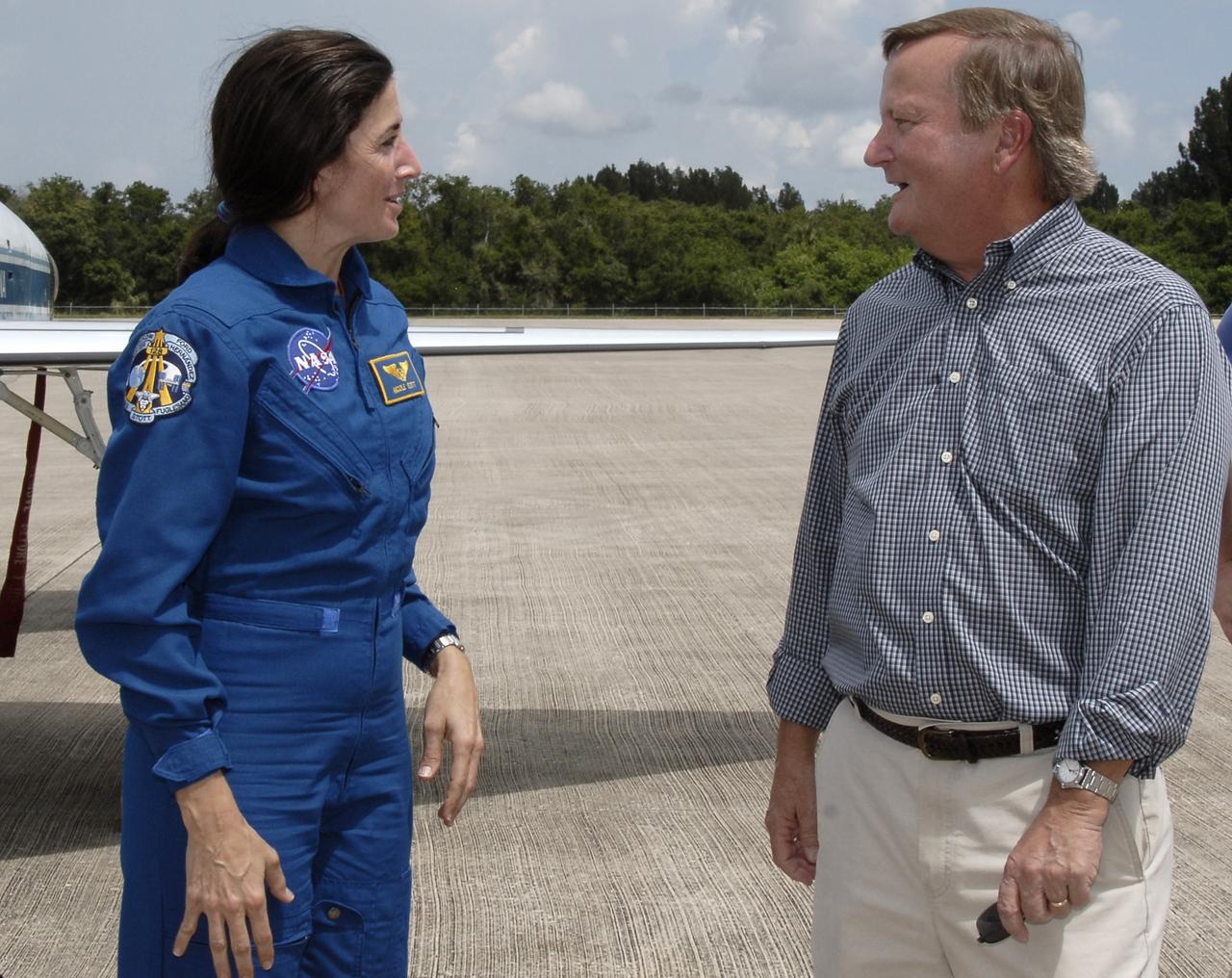 CAPE CANAVERAL, Fla. – Space shuttle Discovery's STS-128 mission crew members arrive in T-38 training jets at NASA Kennedy Space Center's Shuttle Landing Facility. Here, Mission Specialist Nicole Stott is greeted by Shuttle Launch Director Mike Leinbach. Stott will join the Expedition 20 crew on the International Space Station as a flight engineer. The astronauts will be taking part in terminal countdown demonstration test activities that include equipment familiarization and emergency egress training, and will culminate in a simulated launch countdown aboard Discovery. The mission will deliver 33,000 pounds of equipment to the International Space Station. The equipment includes science and storage racks, a freezer to store research samples, a new sleeping compartment and the COLBERT treadmill. Launch of Discovery is targeted for late August. Photo credit: NASA/Kim Shiflett