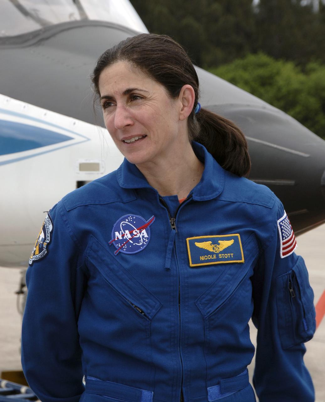 CAPE CANAVERAL, Fla. – Space shuttle Discovery's STS-128 mission crew members arrive in T-38 training jets at NASA Kennedy Space Center's Shuttle Landing Facility.   Mission Specialist Nicole Stott is seen here. Stott will join the Expedition 20 crew on the International Space Station as a flight engineer.  The astronauts will be taking part in terminal countdown demonstration test activities that include equipment familiarization and emergency egress training, and will culminate in a simulated launch countdown aboard Discovery.  The mission will deliver 33,000 pounds of equipment to the International Space Station. The equipment includes science and storage racks, a freezer to store research samples, a new sleeping compartment and the COLBERT treadmill.  Launch of Discovery is targeted for late August. Photo credit: NASA/Kim Shiflett