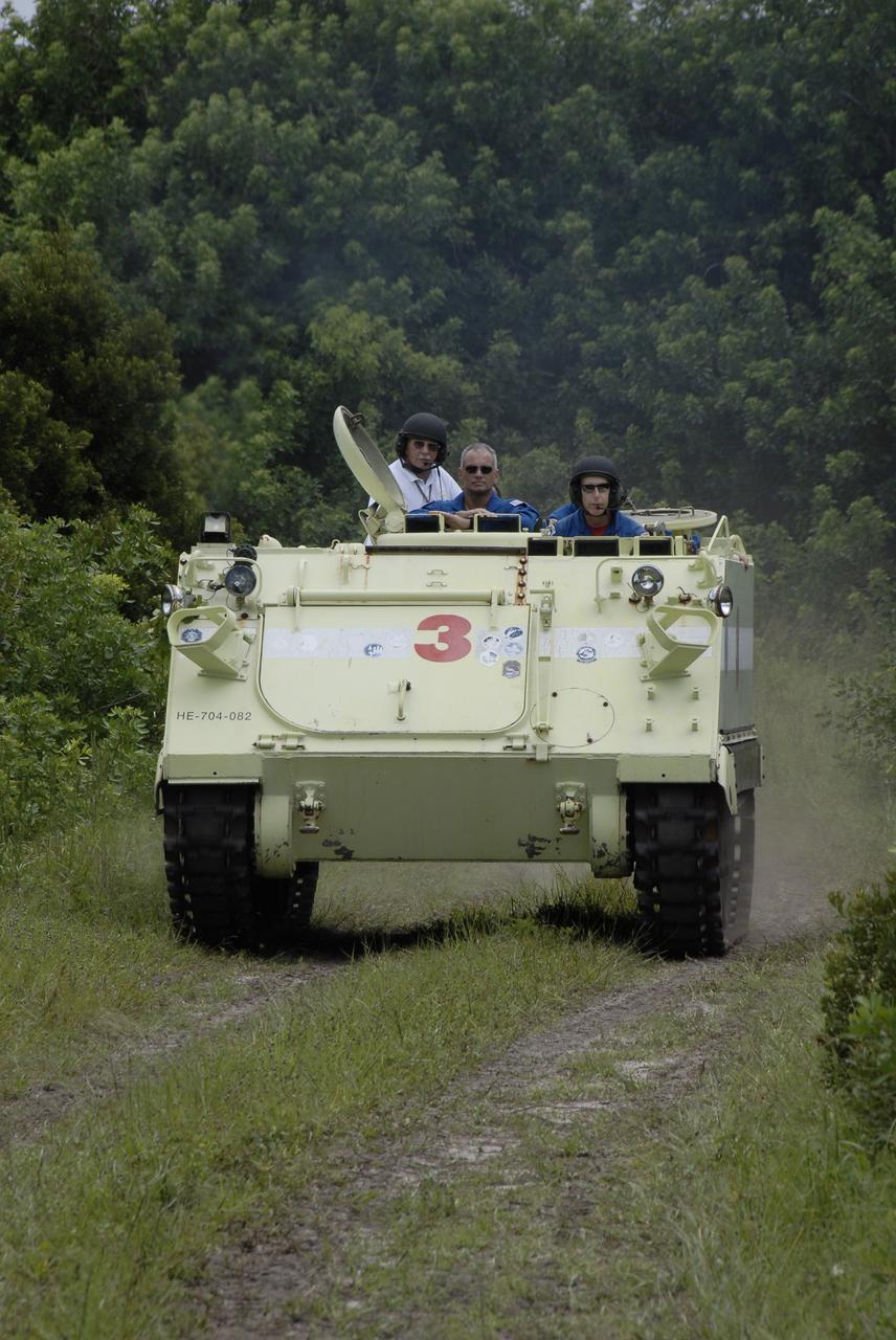 CAPE CANAVERAL, Fla. – At NASA's Kennedy Space Center in Florida, STS-128 Mission Specialist Patrick Forrester takes his turn driving an M-113 armored personnel carrier.  At left is Mission Specialist John "Danny" Olivas.  The crew is at Kennedy for a launch dress rehearsal called the terminal countdown demonstration test, or TCDT, which includes emergency exit training and equipment familiarization, as well as a simulated launch countdown.  Launch of Discovery is targeted for late August. Photo credit: NASA/Kim Shiflett