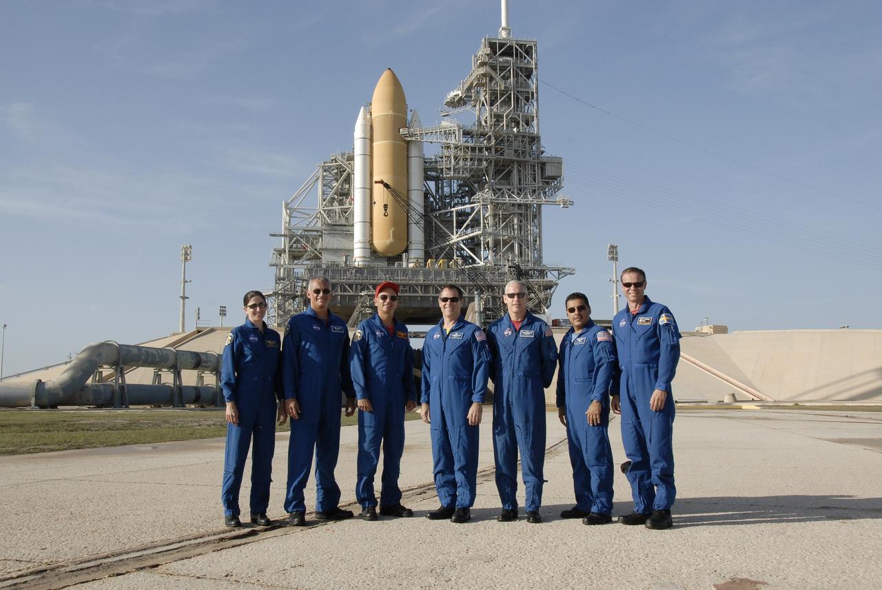CAPE CANAVERAL, Fla. – At NASA's Kennedy Space Center in Florida, STS-128 crew members gather near Launch Pad 39A to answer questions from the media. From left are Mission Specialists Nicole Stott and John "Danny" Olivas, Commander Rick Sturckow, Pilot Kevin Ford and Mission Specialists Patrick Forrester, Jose Hernandez and Christer Fuglesang, who represents the European Space Agency.  On the pad behind them is seen the solid rocket boosters and external fuel tank of space shuttle Discovery.  The crew is at Kennedy for a launch dress rehearsal called the terminal countdown demonstration test, or TCDT, which includes emergency exit training and equipment familiarization, as well as a simulated launch countdown.  Discovery will deliver 33,000 pounds of equipment to the station, including science and storage racks, a freezer to store research samples, a new sleeping compartment and the COLBERT treadmill. Photo credit: NASA/Kim Shiflett