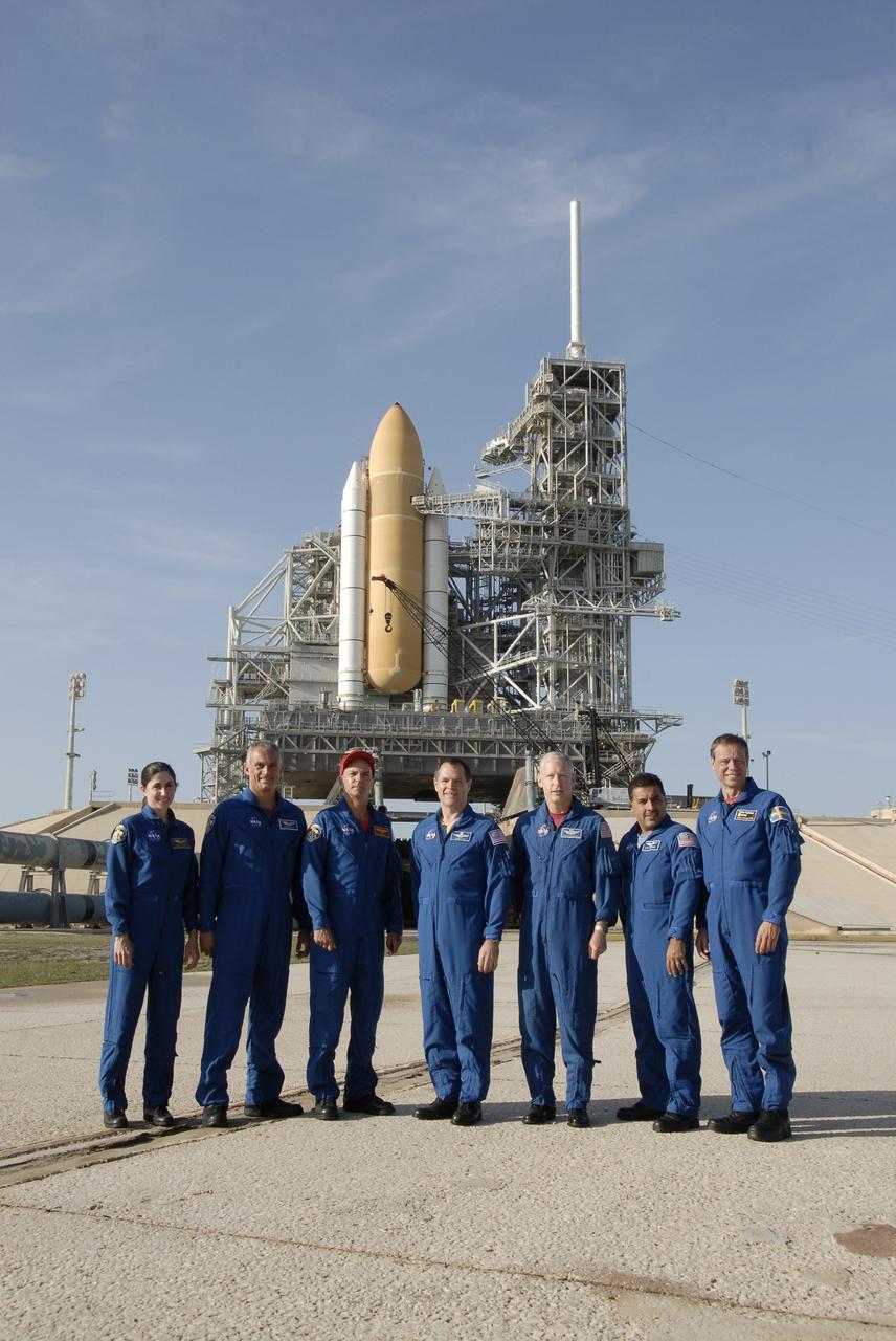 CAPE CANAVERAL, Fla. – At NASA's Kennedy Space Center in Florida, STS-128 crew members gather near Launch Pad 39A to answer questions from the media. From left are Mission Specialists Nicole Stott and John "Danny" Olivas, Commander Rick Sturckow, Pilot Kevin Ford and Mission Specialists Patrick Forrester, Jose Hernandez and Christer Fuglesang, who represents the European Space Agency.  On the pad behind them is seen the solid rocket boosters and external fuel tank of space shuttle Discovery.  On top of the fixed service structure at right is the 80-foot-tall lightning mast.  The crew is at Kennedy for a launch dress rehearsal called the terminal countdown demonstration test, or TCDT, which includes emergency exit training and equipment familiarization, as well as a simulated launch countdown.  Discovery will deliver 33,000 pounds of equipment to the station, including science and storage racks, a freezer to store research samples, a new sleeping compartment and the COLBERT treadmill. Photo credit: NASA/Kim Shiflett