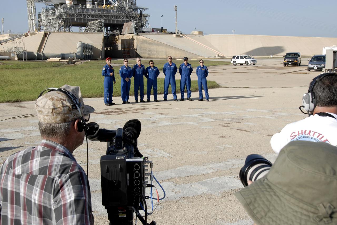 CAPE CANAVERAL, Fla. – Media in the foreground captures images and comments from the STS-128 crew members near Launch Pad 39A at NASA's Kennedy Space Center in Florida.   Commander Rick Sturckow, with the microphone, introduces the rest of the crew, from left, Pilot Kevin Ford and Mission Specialists Patrick Forrester, Jose Hernandez, John "Danny" Olivas, Christer Fuglesang and Nicole Stott.  Fuglesang represents the European Space Agency.  The crew is at Kennedy for a launch dress rehearsal called the terminal countdown demonstration test, or TCDT, which includes emergency exit training and equipment familiarization, as well as a simulated launch countdown.  Discovery will deliver 33,000 pounds of equipment to the station, including science and storage racks, a freezer to store research samples, a new sleeping compartment and the COLBERT treadmill. Photo credit: NASA/Kim Shiflett