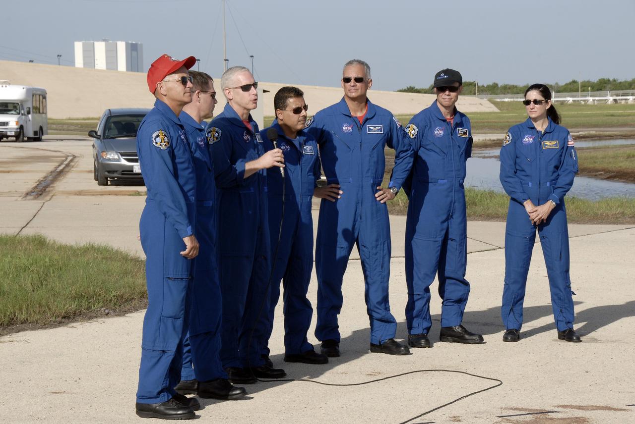 CAPE CANAVERAL, Fla. – Near Launch Pad 39A at NASA's Kennedy Space Center in Florida, STS-128 crew members answer questions from the media.  From left are Commander Rick Sturckow, Pilot Kevin Ford, and Mission Specialists Patrick Forrester (with the microphone), Jose Hernandez, John "Danny" Olivas, Christer Fuglesang and Nicole Stott.  Fuglesang represents the European Space Agency.  The crew is at Kennedy for a launch dress rehearsal called the terminal countdown demonstration test, or TCDT, which includes emergency exit training and equipment familiarization, as well as a simulated launch countdown.  Discovery will deliver 33,000 pounds of equipment to the station, including science and storage racks, a freezer to store research samples, a new sleeping compartment and the COLBERT treadmill. Photo credit: NASA/Kim Shiflett