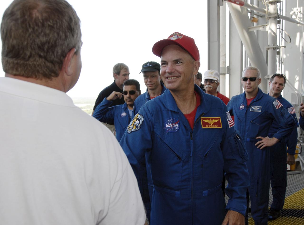 CAPE CANAVERAL, Fla. – At NASA's Kennedy Space Center in Florida, STS-128 crew members get instructions about emergency exit procedures from the fixed service structure on Launch Pad 39A. In front is Commander Rick Sturckow. Seen behind him, at left are Mission Specialists Jose Fernandez (with sunglasses) and Christer Fuglesang, and at right, Mission Specialist Patrick Forrester and Pilot Kevin Ford. Fuglesang represents the European Space Agency. The crew is at Kennedy for a launch dress rehearsal called the terminal countdown demonstration test, or TCDT, which includes emergency exit training and equipment familiarization, as well as a simulated launch countdown. Discovery will deliver 33,000 pounds of equipment to the station, including science and storage racks, a freezer to store research samples, a new sleeping compartment and the COLBERT treadmill. Photo credit: NASA/Kim Shiflett