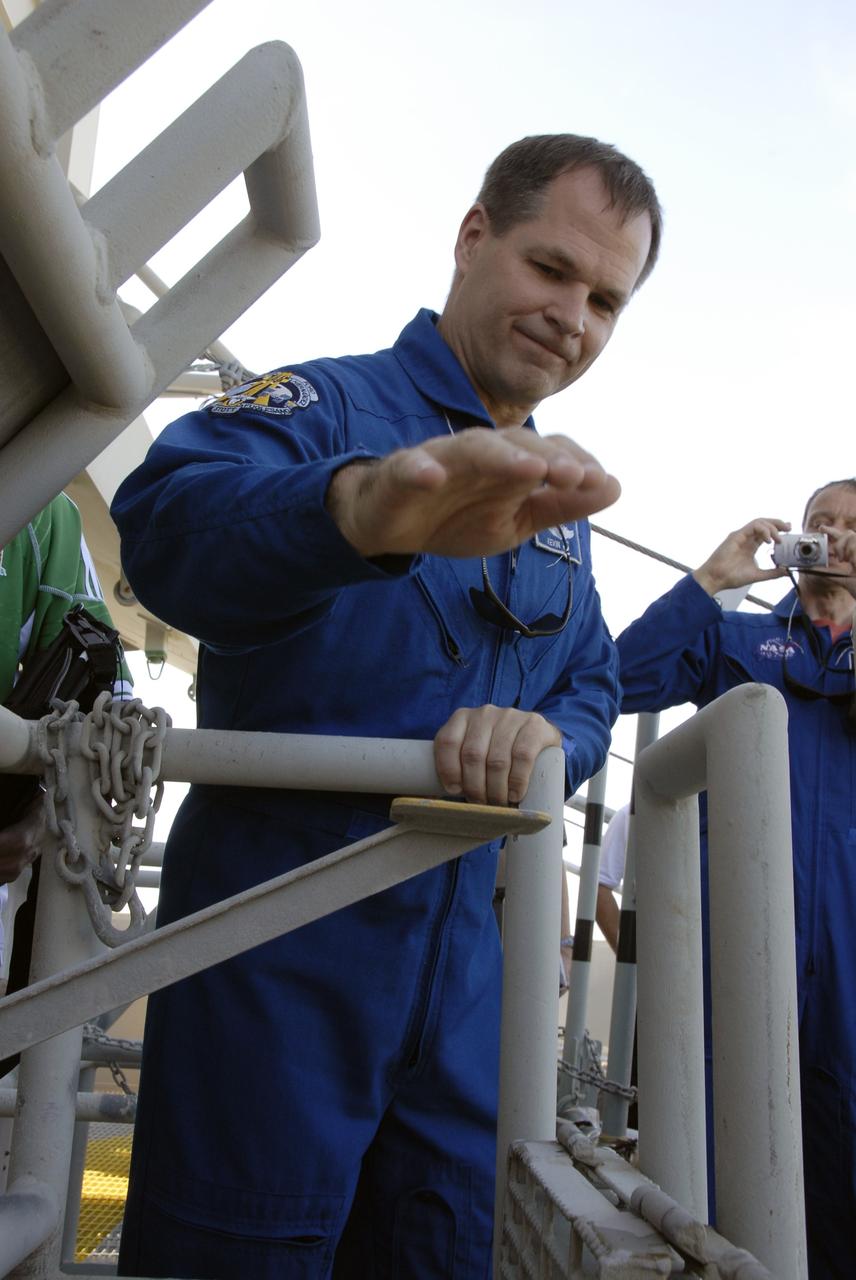 CAPE CANAVERAL, Fla. – STS-128 Pilot Kevin Ford gets ready to push the lever for the slidewire basket on Launch Pad 39A at NASA's Kennedy Space Center in Florida. He and other crew members are being instructed in emergency exit procedures from the pad. The crew is at Kennedy for a launch dress rehearsal called the terminal countdown demonstration test, or TCDT, which includes emergency exit training and equipment familiarization, as well as a simulated launch countdown. Discovery will deliver 33,000 pounds of equipment to the station, including science and storage racks, a freezer to store research samples, a new sleeping compartment and the COLBERT treadmill. Photo credit: NASA/Kim Shiflett