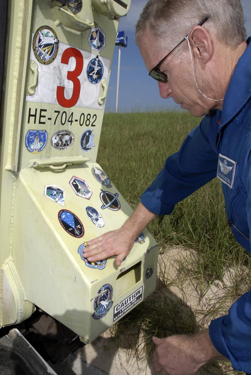 CAPE CANAVERAL, Fla. – At NASA's Kennedy Space Center in Florida, STS-128 Mission Specialist Patrick Forrester places the mission patch on part of the M-113 armored personnel carrier that can be used for emergency exit from the launch pad. The crew is at Kennedy for a launch dress rehearsal called the terminal countdown demonstration test, or TCDT, which includes emergency exit training and equipment familiarization, as well as a simulated launch countdown. Discovery will deliver 33,000 pounds of equipment to the station, including science and storage racks, a freezer to store research samples, a new sleeping compartment and the COLBERT treadmill. Photo credit: NASA/Kim Shiflett