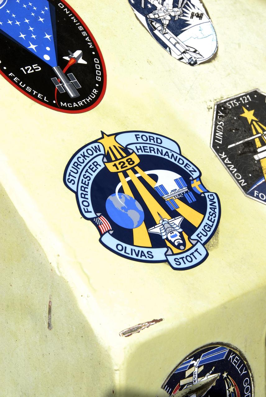 CAPE CANAVERAL, Fla. – A closeup of the STS-128 mission patch placed on the M-113 armored personnel carrier that can be used for emergency exit from Launch Pad 39A at NASA's Kennedy Space Center in Florida. The crew is at Kennedy for a launch dress rehearsal called the terminal countdown demonstration test, or TCDT, which includes emergency exit training and equipment familiarization, as well as a simulated launch countdown. Discovery will deliver 33,000 pounds of equipment to the station, including science and storage racks, a freezer to store research samples, a new sleeping compartment and the COLBERT treadmill. Photo credit: NASA/Kim Shiflett