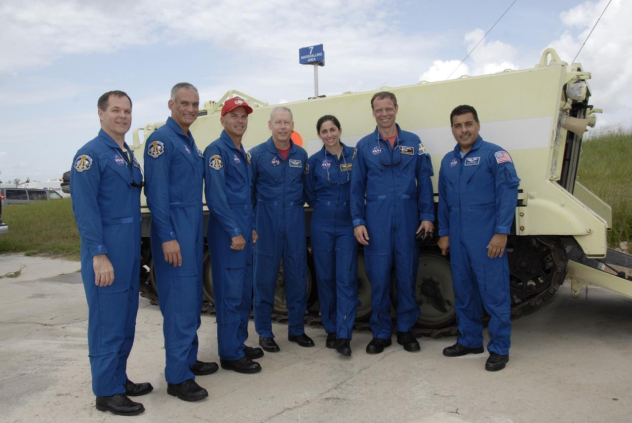 CAPE CANAVERAL, Fla. – At NASA's Kennedy Space Center in Florida, STS-128 crew members have completed emergency exit training on Launch Pad 39A. Standing in front of an M-113 armored personnel carrier are, from left, Pilot Kevin Ford, Mission Specialist John "Danny" Olivas, Commander Rick Sturckow, and Mission Specialists Patrick Forrester, Nicole Stott, Christer Fuglesang and Jose Hernandez.  Fuglesang represents the European Space Agency.  The crew is at Kennedy for a launch dress rehearsal called the terminal countdown demonstration test, or TCDT, which includes emergency exit training and equipment familiarization, as well as a simulated launch countdown.  Discovery will deliver 33,000 pounds of equipment to the station, including science and storage racks, a freezer to store research samples, a new sleeping compartment and the COLBERT treadmill. Photo credit: NASA/Kim Shiflett