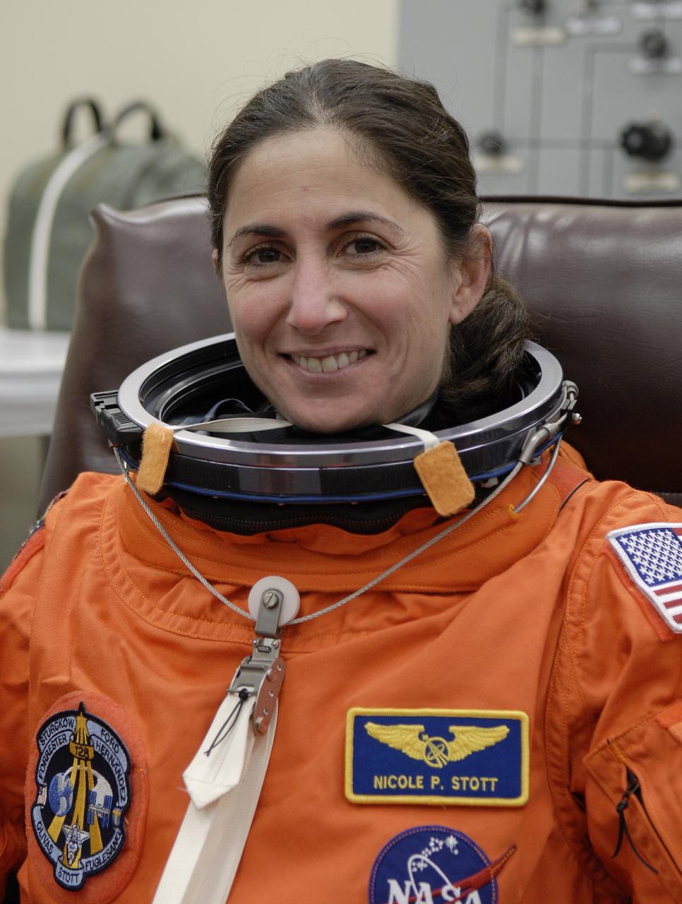 CAPE CANAVERAL, Fla. – STS-128 Mission Specialist Nicole Stott is donning her launch and entry suit for a fit check before the simulated launch countdown at NASA Kennedy Space Center's Launch Pad 39A. The countdown is the culmination of terminal countdown demonstration test activities to prepare the STS-128 crew for launch on space shuttle Discovery's STS-128 mission. Discovery will deliver 33,000 pounds of equipment to the station, including science and storage racks, a freezer to store research samples, a new sleeping compartment and the COLBERT treadmill. Launch is targeted for late August. Photo credit: NASA/Kim Shiflett