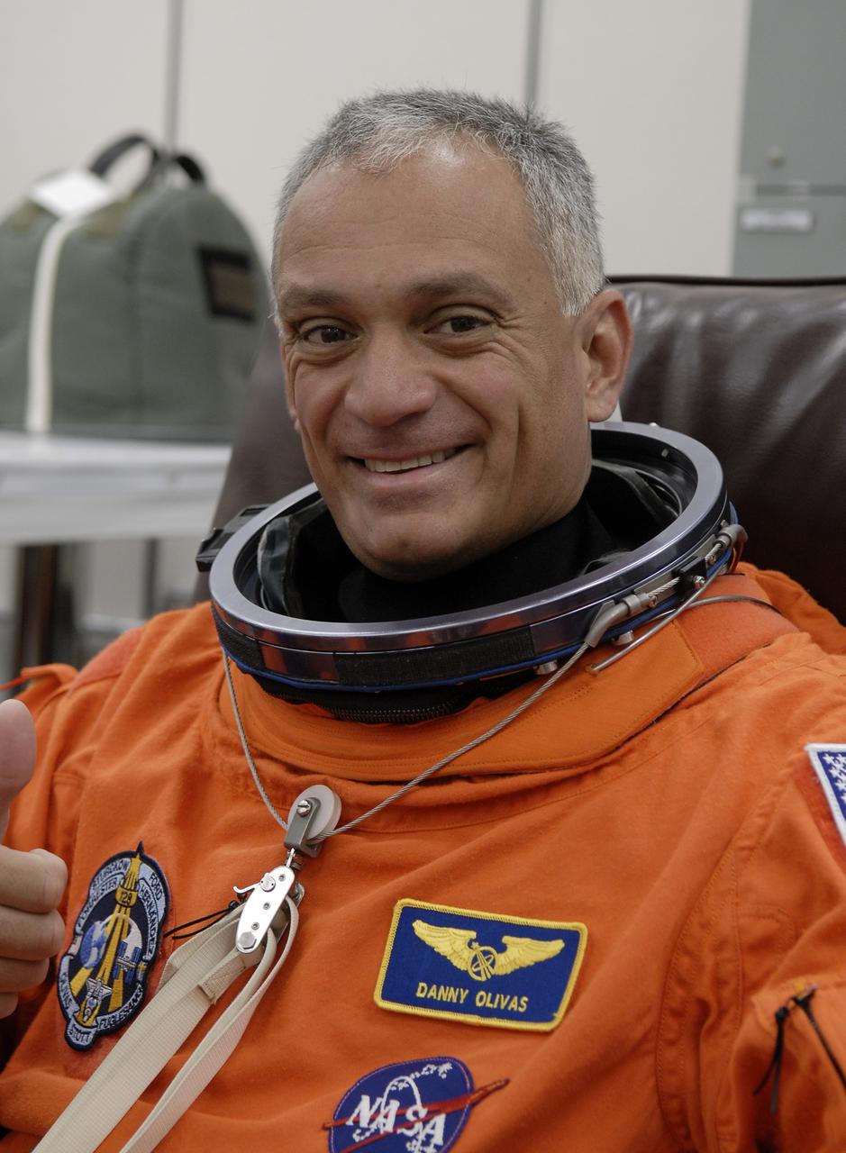 CAPE CANAVERAL, Fla. – STS-128 Mission Specialist Danny Olivas is donning his launch and entry suit for a fit check before the simulated launch countdown at NASA Kennedy Space Center's Launch Pad 39A. The countdown is the culmination of terminal countdown demonstration test activities to prepare the STS-128 crew for launch on space shuttle Discovery's STS-128 mission. Discovery will deliver 33,000 pounds of equipment to the station, including science and storage racks, a freezer to store research samples, a new sleeping compartment and the COLBERT treadmill. Launch is targeted for late August. Photo credit: NASA/Kim Shiflett