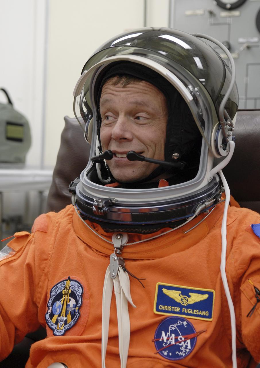 CAPE CANAVERAL, Fla. – STS-128 Mission Specialist Christer Fuglesang tests the fit of his helmet before heading to the NASA Kennedy Space Center's Launch Pad 39A for the simulated launch countdown. The countdown is the culmination of terminal countdown demonstration test activities to prepare the STS-128 crew for launch on space shuttle Discovery's STS-128 mission. Discovery will deliver 33,000 pounds of equipment to the station, including science and storage racks, a freezer to store research samples, a new sleeping compartment and the COLBERT treadmill. Launch is targeted for late August. Photo credit: NASA/Kim Shiflett