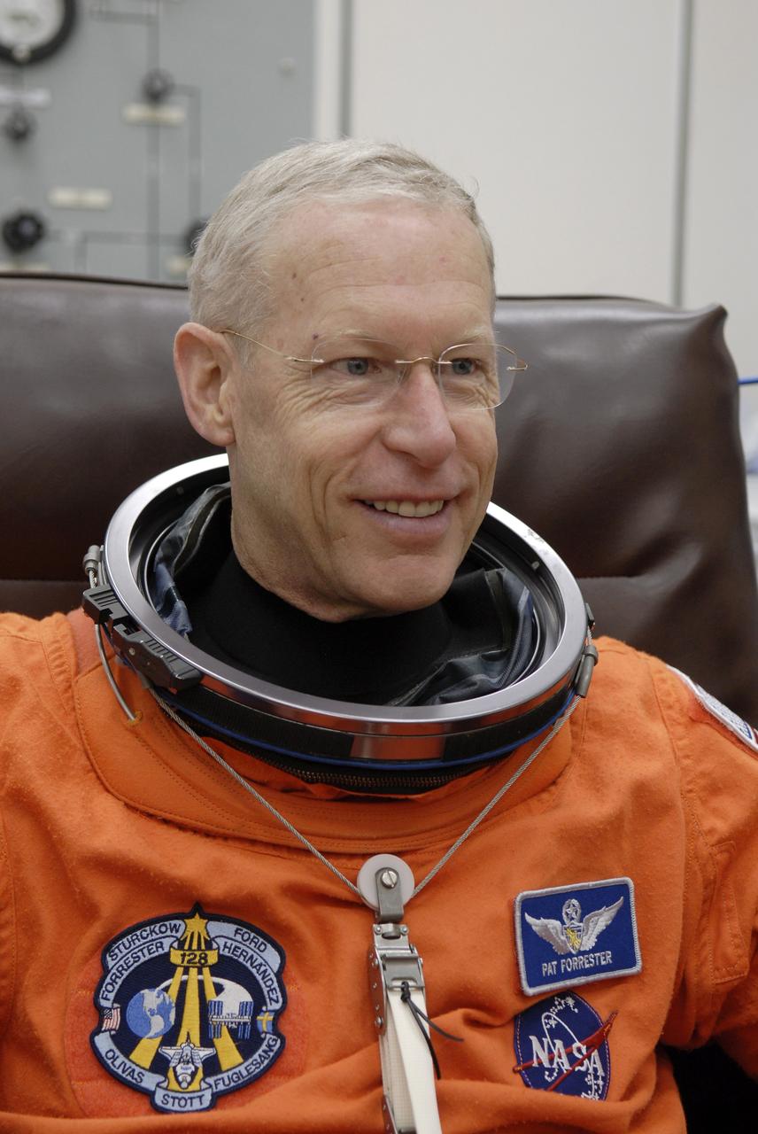 CAPE CANAVERAL, Fla. – STS-128 Mission Specialist Patrick Forrester checks the fit of his launch and entry suit before heading to the NASA Kennedy Space Center's Launch Pad 39A for the simulated launch countdown. The countdown is the culmination of terminal countdown demonstration test activities to prepare the STS-128 crew for launch on space shuttle Discovery's STS-128 mission. Discovery will deliver 33,000 pounds of equipment to the station, including science and storage racks, a freezer to store research samples, a new sleeping compartment and the COLBERT treadmill. Launch is targeted for late August. Photo credit: NASA/Kim Shiflett